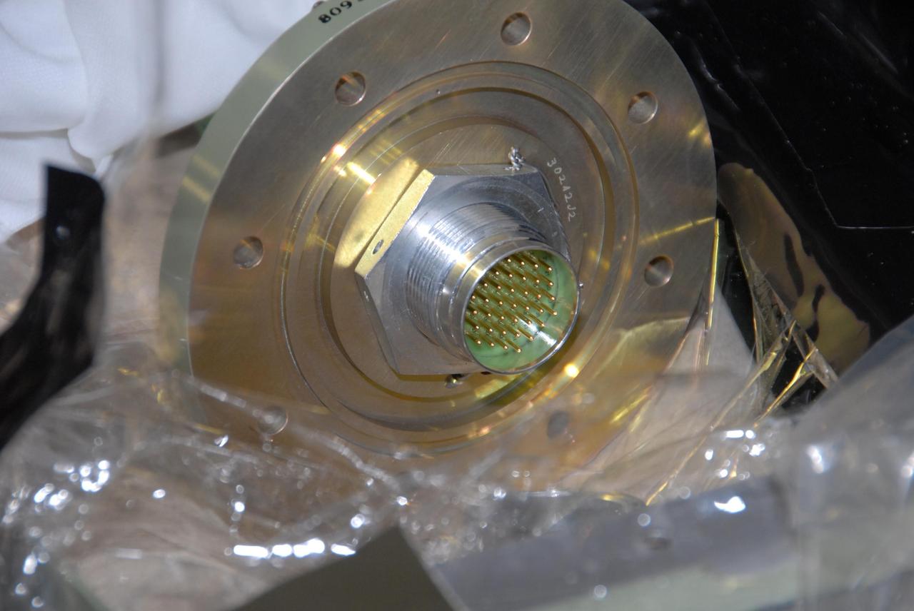 KENNEDY SPACE CENTER, FLA. --  This closeup of the replacement feed-through connector for the engine cutoff, or ECO, sensor system on space shuttle Atlantis shows the pins that were soldered at Kennedy.  The feed-through connector passes the wires from the inside of the tank to the outside.  Results of a tanking test on Dec. 18 pointed to an open circuit in the feed-through connector wiring, which is located at the base of the tank. The pins in the replacement connector have been precisely soldered to create a connection that allows sensors inside the tank to send signals to the computers onboard Atlantis. The work is being done on Launch Pad 39A.   Space shuttle Atlantis is now targeted for launch on Feb. 7.  Photo credit: NASA/George Shelton