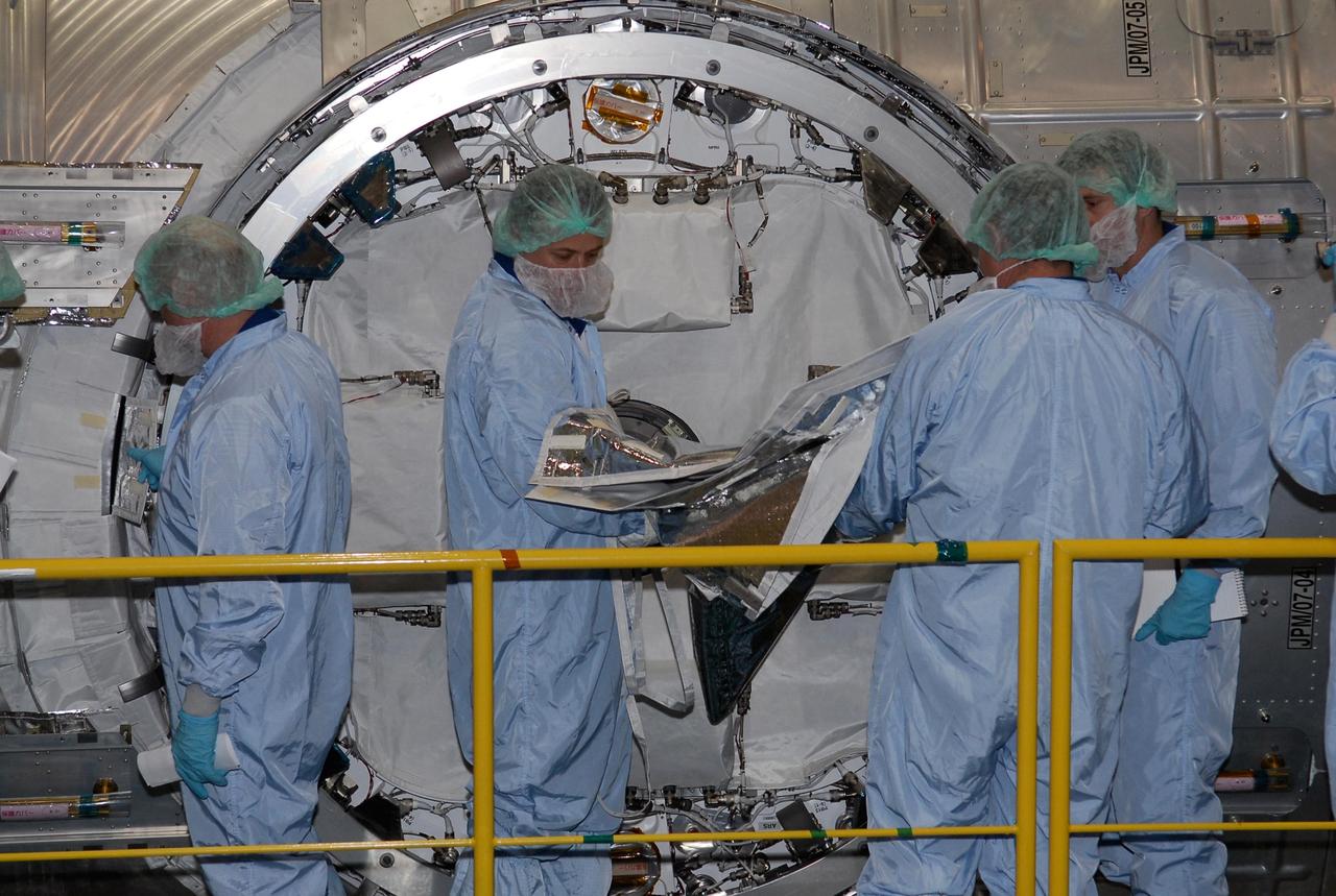 KENNEDY SPACE CENTER, FLA. -- In the Space Station Processing Facility at NASA's Kennedy Space Center, members of the STS-124 crew look over equipment related to the scientific airlock in the Kibo pressurized module. The module is part of the payload for the mission, targeted for launch no earlier than April 24. The crew comprises seven: Commander Mark Kelly, Pilot Kenneth Ham, and Mission Specialists Karen Nyberg, Ronald Garan, Michael Fossum and Akihiko Hoshide. The crew is at Kennedy for a crew equipment interface test that includes familiarization with tools and equipment that will be used on the mission. The STS-124 mission is the second of three flights that will launch components to complete the Japanese pressurized module, the Kibo laboratory. The mission will include two spacewalks to install the new lab and its remote manipulator system. The lab's logistics module, which will have been installed in a temporary location during STS-123, will be attached to the new lab. Photo credit: NASA/Kim Shiflett
