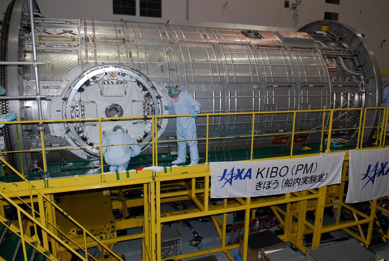 KENNEDY SPACE CENTER, FLA. -- In the Space Station Processing Facility at NASA's Kennedy Space Center, members of the STS-124 crew look over equipment related to the scientific airlock in the Kibo pressurized module. The module is part of the payload for the mission, targeted for launch no earlier than April 24. The crew comprises seven: Commander Mark Kelly, Pilot Kenneth Ham, and Mission Specialists Karen Nyberg, Ronald Garan, Michael Fossum and Akihiko Hoshide. The crew is at Kennedy for a crew equipment interface test that includes familiarization with tools and equipment that will be used on the mission. The STS-124 mission is the second of three flights that will launch components to complete the Japanese pressurized module, the Kibo laboratory. The mission will include two spacewalks to install the new lab and its remote manipulator system. The lab's logistics module, which will have been installed in a temporary location during STS-123, will be attached to the new lab. Photo credit: NASA/Kim Shiflett