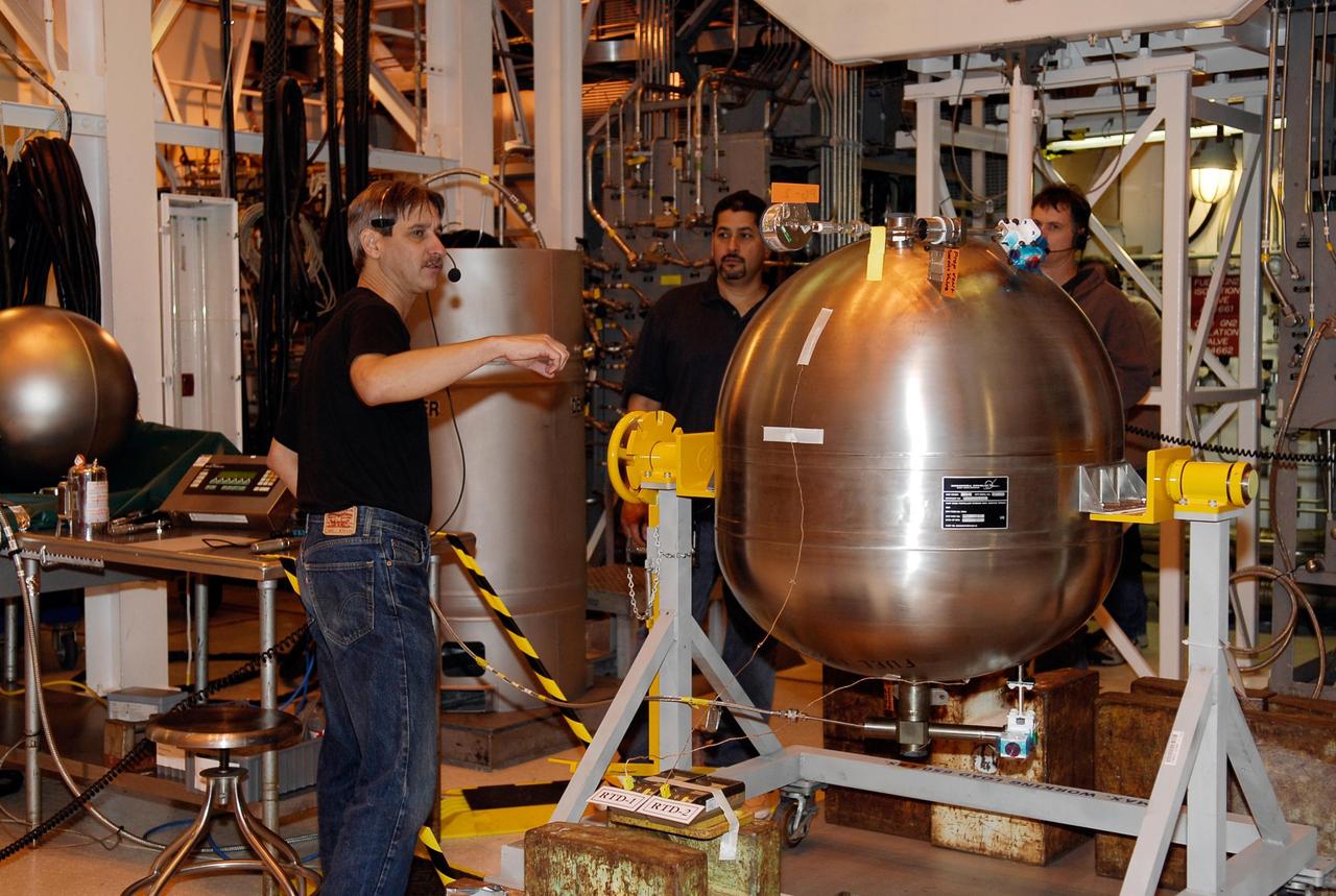 KENNEDY SPACE CENTER, FLA. -- In the hypergolic maintenance facility at NASA's Kennedy Space Center, technicians look at some of the elements to be tested in the Ares I-X Roll Control System, or RoCS. The RoCS Servicing Simulation Test is to gather data that will be used to help certify the ground support equipment design and validate the servicing requirements and processes. The RoCS is part of the Interstage structure, the lowest axial segment of the Upper Stage Simulator. In an effort to reduce costs and meet the schedule, most of the ground support equipment that will be used for the RoCS servicing is of space shuttle heritage. This high-fidelity servicing simulation will provide confidence that servicing requirements can be met with the heritage system. At the same time, the test will gather process data that will be used to modify or refine the equipment and processes to be used for the actual flight element. Photo credit: NASA/Kim Shiflett