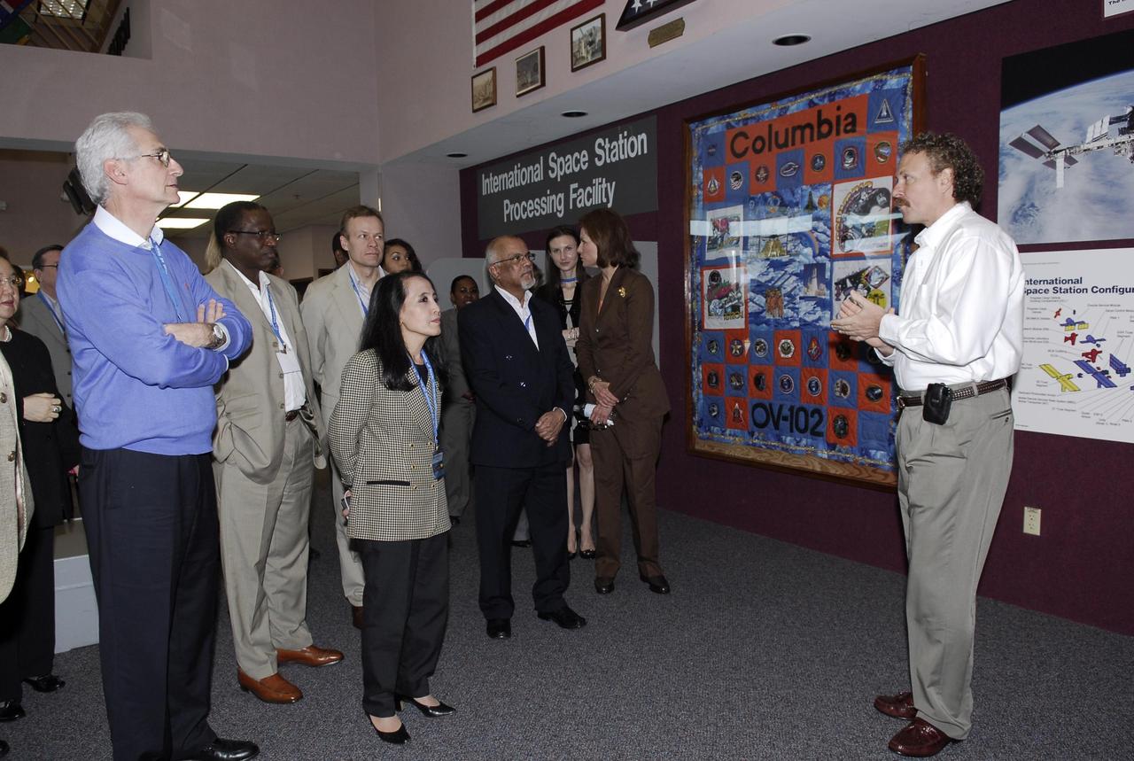 KENNEDY SPACE CENTER, FLA. -- A group of The Chiefs of Diplomatic Missions from more than 45 countries tour the Space Station Processing Facility.  At right, Russell Romanella, director of the International Space Station and Payload Processing Directorate, talks about the space station program.  The visit, one of the largest tours undertaken by the diplomatic corps, is part of the State Department's new Experience America program. The international dignitaries were provided an overview of the United States' space exploration programs and NASA's international cooperation in pursuit of exploration and scientific discovery. They visited various locations at Kennedy, including the Space Station Processing Facility and Launch Pad 39A where space shuttle Atlantis is being prepared for its upcoming mission to the International Space Station.   Photo credit: NASA/Kim Shiflett