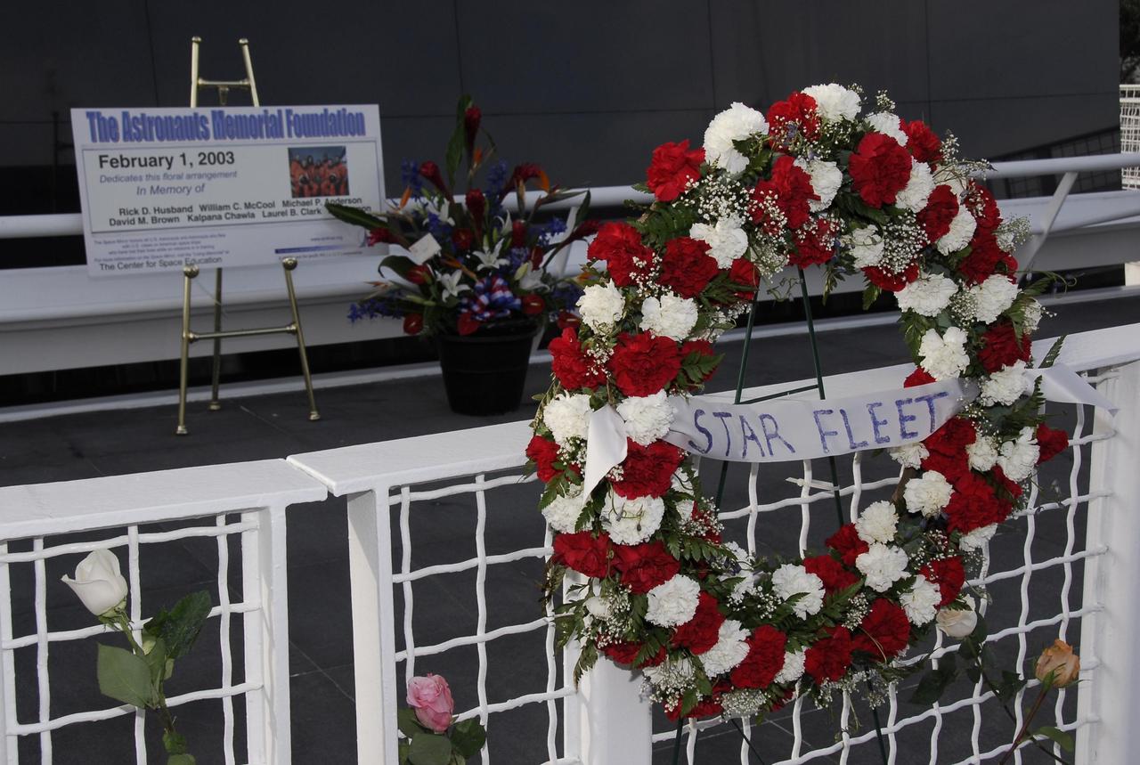 KENNEDY SPACE CENTER, FLA. -- A wreath is suspended in front the Space Mirror Memorial at NASA's Kennedy Space Center Visitor Complex in memory of the fallen astronauts who passed away in their journeys of exploration.  Kennedy marked the NASA Day of Remembrance with special ceremonies.  This year the crew of Columbia was remembered in a special way on the day that marked the fifth anniversary of the Columbia accident.   Photo credit: NASA/Kim Shiflett