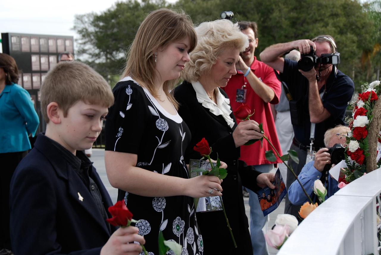 KENNEDY SPACE CENTER, FLA. -- Evelyn Husband-Thompson, widow of shuttle commander Rick Husband on  mission STS-107, and her children place flowers at the memorial dedicated to the seven crew members of Columbia who were lost as they returned from the mission. Husband-Thompson participated in the special event held to honor NASA's fallen heroes in front of the Space Mirror Memorial at NASA's Kennedy Space Center Visitor Complex.  Kennedy marked the NASA Day of Remembrance with special ceremonies.  This year the crew of Columbia was remembered in a special way on the day that marked the fifth anniversary of the Columbia accident.   Photo credit: NASA/Kim Shiflett