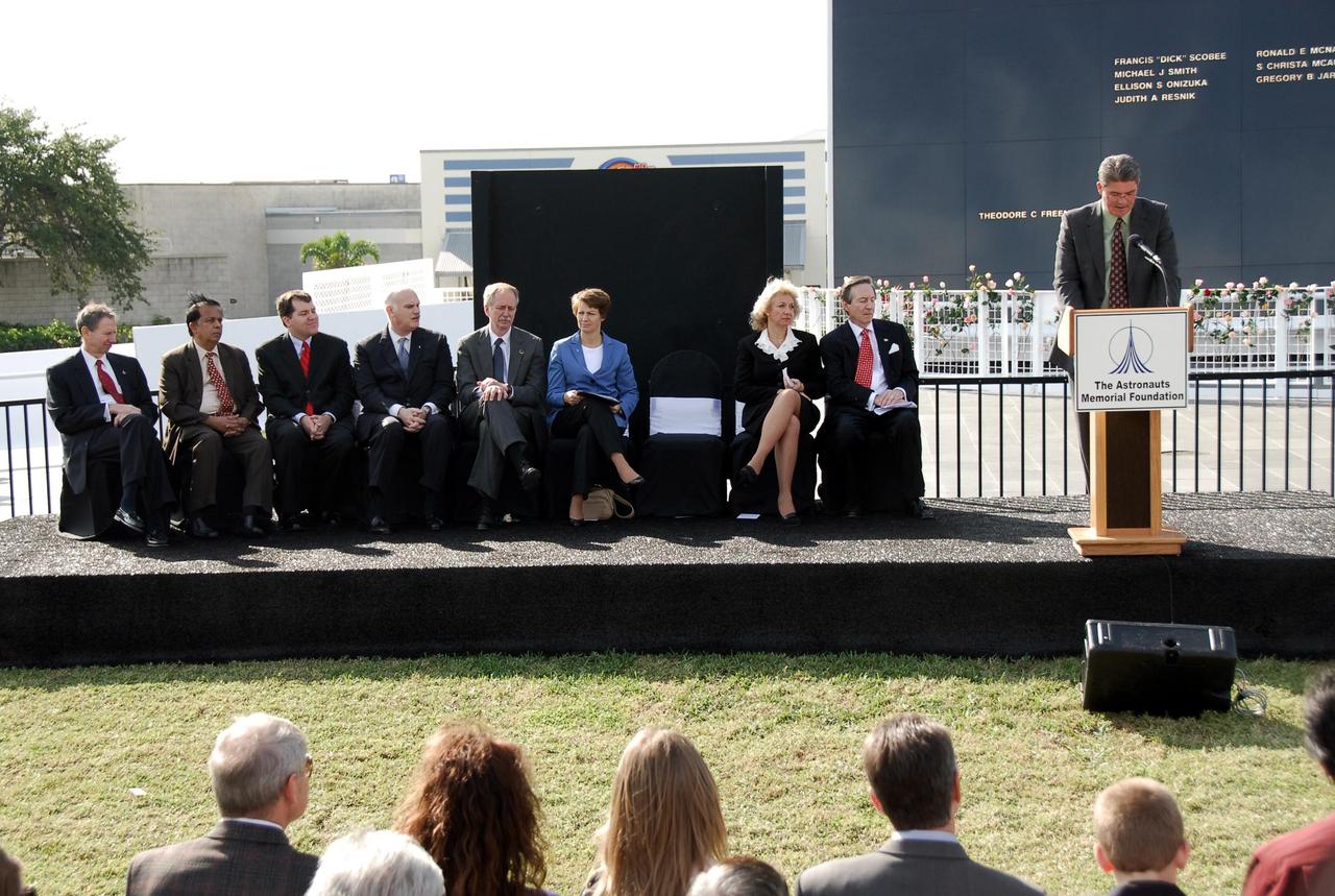 KENNEDY SPACE CENTER, FLA. -- In a special commemorative service held at NASA's Kennedy Space Center Visitor Complex to honor NASA's fallen heroes, Kennedy Center Director Bill Parsons speaks to guests gathered in front of the Space Mirror Memorial.  Other participants seated on the dais are (from left) NASA Administrator Michael Griffin; Chairman of the Indian Space Research Organization G. Madhavan Nair; the 2007 Alan Shepard Technology in Education Award winner Luther Richardson; Shuttle Commander and former NASA Associate Administrator for Space Operations William Readdy; NASA Associate Administrator for Space Operations William Gerstenmaier; Shuttle Commander Eileen Collins of the Return to Flight mission, STS-114; Evelyn Husband-Thompson, widow of Colonel Rick Husband; and Astronauts Memorial Foundation President Stephen Feldman.  Kennedy marked the NASA Day of Remembrance with special ceremonies.  This year the crew of Columbia was remembered in a special way on the day that marked the fifth anniversary of the Columbia accident.   Photo credit: NASA/Kim Shiflett