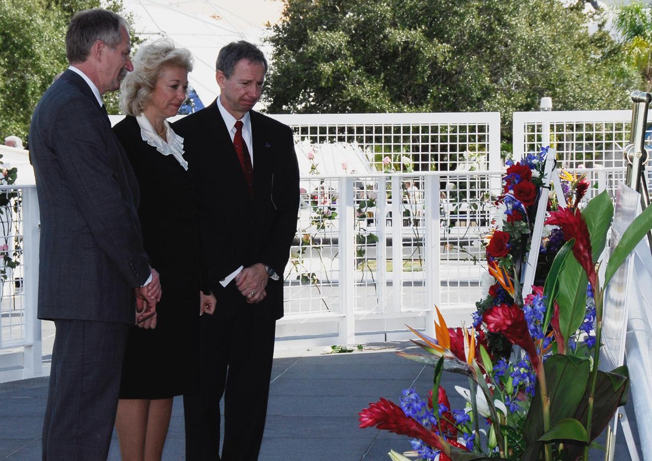 KENNEDY SPACE CENTER, FLA. -- (From left) NASA Associate Administrator for Space Operations William Gerstenmaier; Evelyn Husband-Thompson, widow of Colonel Rick Husband, who died in the space shuttle Columbia accident; and NASA Administrator Michael Griffin pause in front of the flowers left in remembrance of the fallen heroes.   Kennedy marked the NASA Day of Remembrance with special ceremonies.  This year the crew of Columbia was remembered in a special way on the day that marked the fifth anniversary of the Columbia accident.   Photo credit: NASA/Kim Shiflett