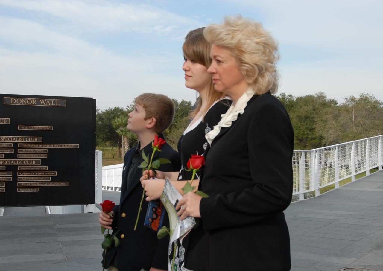 KENNEDY SPACE CENTER, FLA. -- Evelyn Husband-Thompson, widow of shuttle commander Rick Husband on  mission STS-107, and her children pause in front of the memorial dedicated to the crew of Columbia who were lost as they returned from the mission. Husband-Thompson participated in the special event held to honor NASA's fallen heroes in front of the Space Mirror Memorial at NASA's Kennedy Space Center Visitor Complex. Kennedy marked the NASA Day of Remembrance with special ceremonies.  This year the crew of Columbia was remembered in a special way on the day that marked the fifth anniversary of the Columbia accident.   Photo credit: NASA/George Shelton