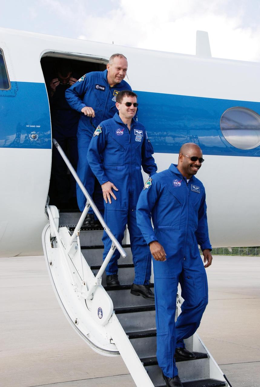 KENNEDY SPACE CENTER, FLA. -- At NASA's Kennedy Space Center, STS-122 mission specialists disembark from a shuttle training aircraft. From left are Hans Schlegel, Rex Walheim and Leland Melvin. Schlegel represents the European Space Agency. Schlegel represents the European Space Agency. The crew's arrival signals the imminent launch of space shuttle Atlantis' STS-122 mission, at 2:45 p.m. Feb. 7. This will be the third launch attempt for the mission. Some of the tank's ECO sensors gave failed readings during propellant tanking for launch attempts on Dec. 6 and Dec. 9, subsequently scrubbing further attempts until the cause could be found and repairs made. Atlantis will carry the Columbus module, Europe's largest contribution to the construction of the International Space Station. It will support scientific and technological research in a microgravity environment. Columbus is a multifunctional, pressurized laboratory that will be permanently attached to the Harmony module of the space station to carry out experiments in materials science, fluid physics and biosciences, as well as to perform a number of technological applications. Photo credit: NASA/Kim Shiflett