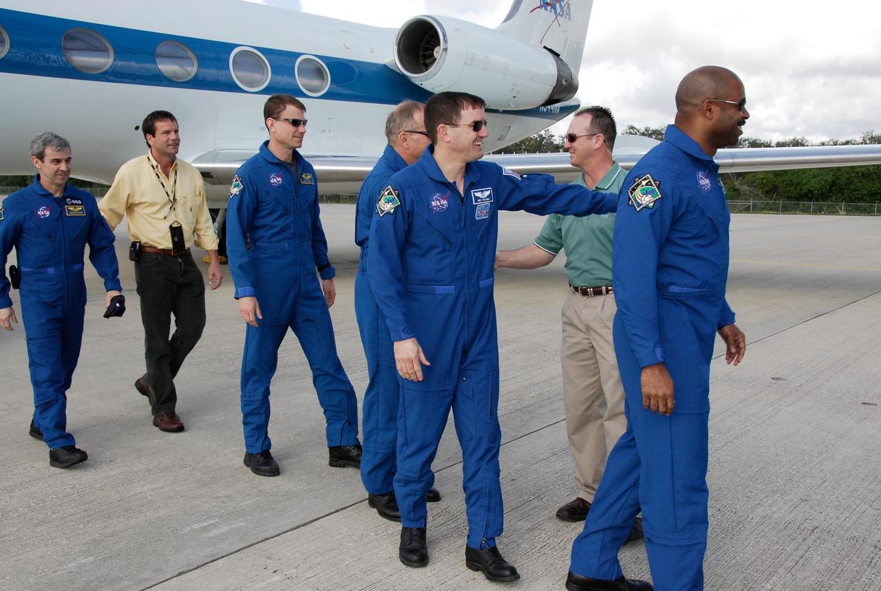KENNEDY SPACE CENTER, FLA. -- At NASA's Kennedy Space Center, members of the STS-122 crew arrive for launch. From left are Mission Specialists Leopold Eyharts, Stanley Love, Hans Schlegel, Rex Walheim and Leland Melvin. They were greeted by Doug Lyons (left, yellow shirt), launch director for the mission, and Pete Nickolenko (right, green shirt), lead shuttle test director. Eyharts and Schlegel represent the European Space Agency. The crew's arrival signals the imminent launch of space shuttle Atlantis' STS-122 mission, at 2:45 p.m. Feb. 7. This will be the third launch attempt for the mission. Some of the tank's ECO sensors gave failed readings during propellant tanking for launch attempts on Dec. 6 and Dec. 9, subsequently scrubbing further attempts until the cause could be found and repairs made. Atlantis will carry the Columbus module, Europe's largest contribution to the construction of the International Space Station. It will support scientific and technological research in a microgravity environment. Columbus is a multifunctional, pressurized laboratory that will be permanently attached to the Harmony module of the space station to carry out experiments in materials science, fluid physics and biosciences, as well as to perform a number of technological applications. Photo credit: NASA/Kim Shiflett