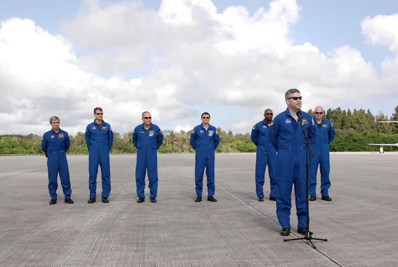 KENNEDY SPACE CENTER, FLA. -- After their arrival at NASA's Kennedy Space Center, the STS-122 crew gathers on the Shuttle Landing Facility to talk to the media. At the microphone is Commander Steve Frick. Behind him are Mission Specialists Leopold Eyharts, Stanley Love, Hans Schlegel, Rex Walheim and Leland Melvin, and Pilot Alan Poindexter. Eyharts and Schlegel represent the European Space Agency.The crew's arrival signals the imminent launch of space shuttle Atlantis' STS-122 mission, at 2:45 p.m. Feb. 7. This will be the third launch attempt for the mission. Some of the tank's ECO sensors gave failed readings during propellant tanking for launch attempts on Dec. 6 and Dec. 9, subsequently scrubbing further attempts until the cause could be found and repairs made. Atlantis will carry the Columbus module, Europe's largest contribution to the construction of the International Space Station. It will support scientific and technological research in a microgravity environment. Columbus is a multifunctional, pressurized laboratory that will be permanently attached to the Harmony module of the space station to carry out experiments in materials science, fluid physics and biosciences, as well as to perform a number of technological applications. Photo credit: NASA/Kim Shiflett