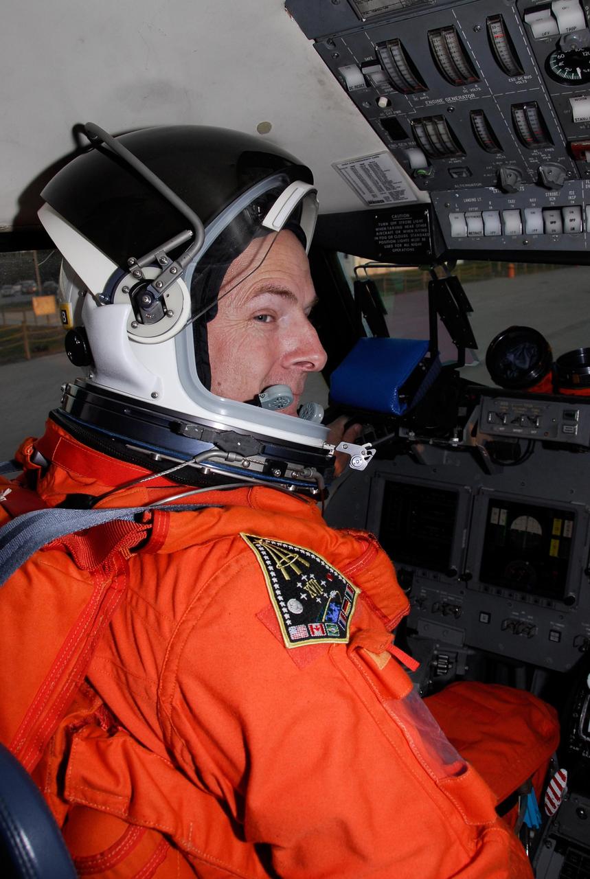 KENNEDY SPACE CENTER, FLA. --  Dressed in his launch and entry suit, STS-122 Pilot Alan Poindexter is seated in the shuttle training aircraft, or STA, at NASA's Kennedy Space Center. Poindexter and Commander Steve Frick are practicing shuttle landings in the STA before the Feb. 7 launch of space shuttle Atlantis.  The STA is a Grumman American Aviation-built Gulf Stream II jet that was modified to simulate an orbiter's cockpit, motion and visual cues, and handling qualities. In flight, the STA duplicates the orbiter's atmospheric descent trajectory from approximately 35,000 feet altitude to landing on a runway. Because the orbiter is unpowered during re-entry and landing, its high-speed glide must be perfectly executed the first time.  Photo credit: NASA/Kim Shiflett