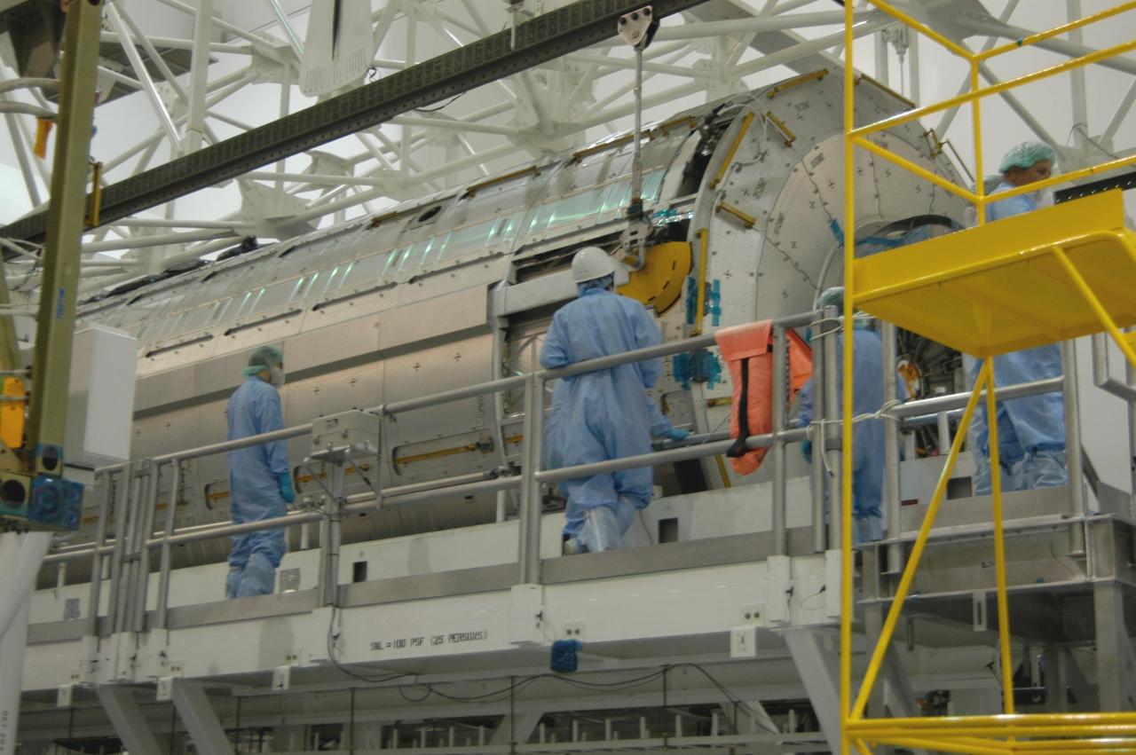 KENNEDY SPACE CENTER, FLA. --In the Space Station Processing Facility at NASA's Kennedy Space Center, workers stand by as an overhead crane lowers the Japanese Experiment Module, called Kibo, onto the scale for weighing. Also known as the JEM-PM, the module is the primary payload for space shuttle Discovery's STS-124 mission, which is targeted for launch to the International Space Station on April 24. Photo credit: NASA/Jim Cain