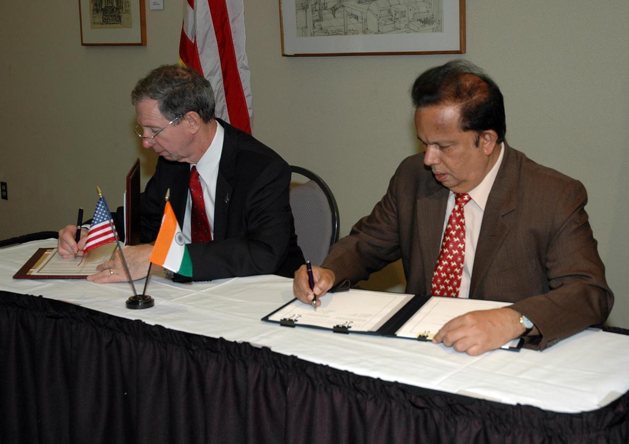 KENNEDY SPACE CENTER, FLA. -- At a ceremony at the NASA's Kennedy Space Center Visitor Complex, NASA Administrator Michael Griffin (left) and Indian Space Research Organization Chairman G. Madhavan Nair sign a framework agreement establishing the terms for future cooperation between the two agencies in the exploration and use of outer space for peaceful purposes. According to the framework agreement, the two agencies will identify areas of mutual interest and seek to develop cooperative programs or projects in Earth and space science, exploration, human space flight and other activities. In addition to a long history of cooperation in Earth science, NASA and the Indian Space Research Organization also are cooperating on India's first, mission to the moon, Chandrayaan-1, which will be launched later this year. NASA is providing two of the 11 instruments on the spacecraft: the moon mineralogy mapper instrument and the miniature synthetic aperture radar instrument. Photo credit: NASA/Kim Shiflett