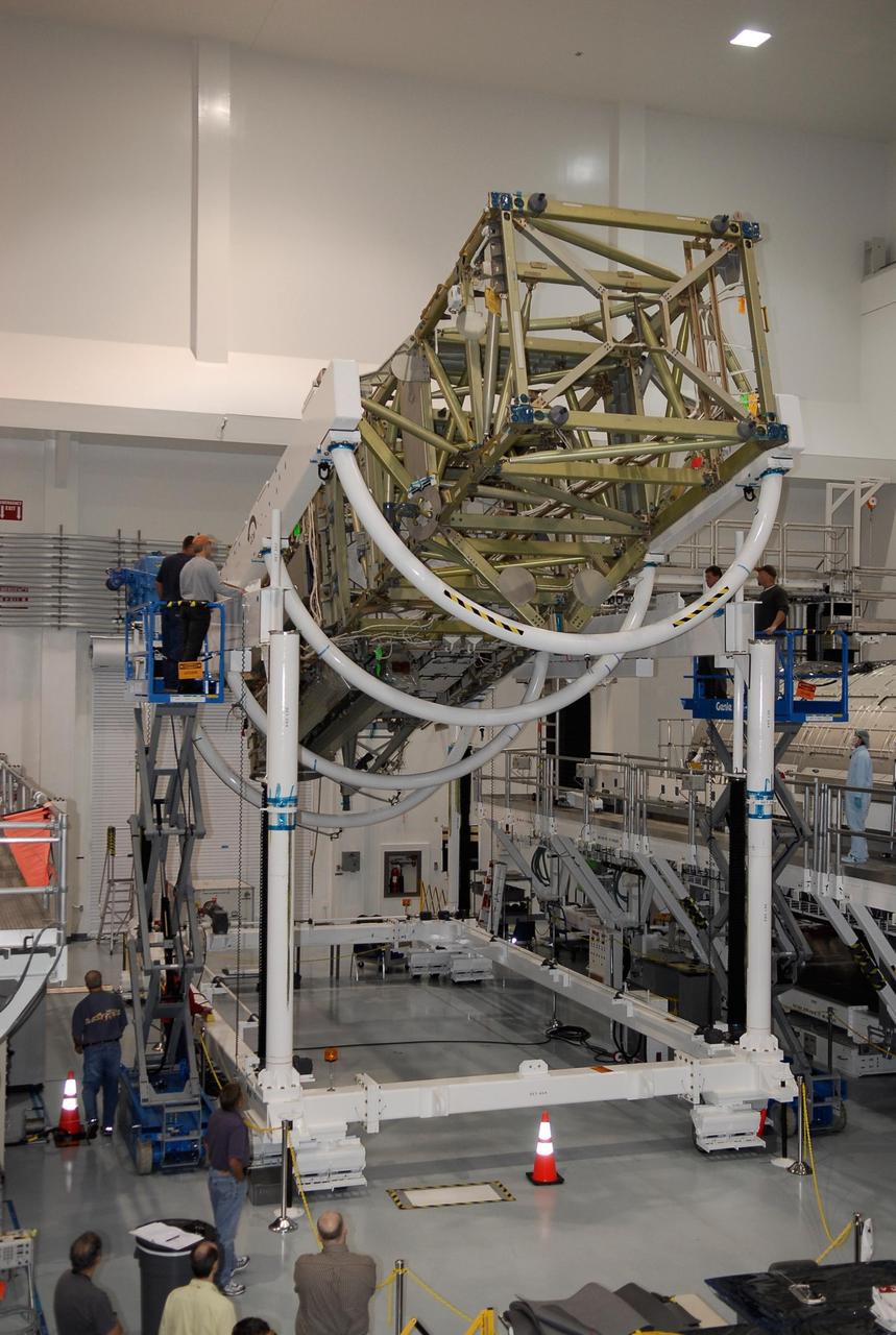 KENNEDY SPACE CENTER, FLA. -- In the Space Station Processing Facility at NASA's Kennedy Space Center, workers stand ready as the starboard integrated truss, known as S6, is rotated in order to remove and replace lower deck batteries. The final starboard truss in the assembly of the International Space Station, the S6 is scheduled to fly on the STS-119 space shuttle mission, whose launch date is not yet determined. Photo credit: NASA/Kim Shiflett