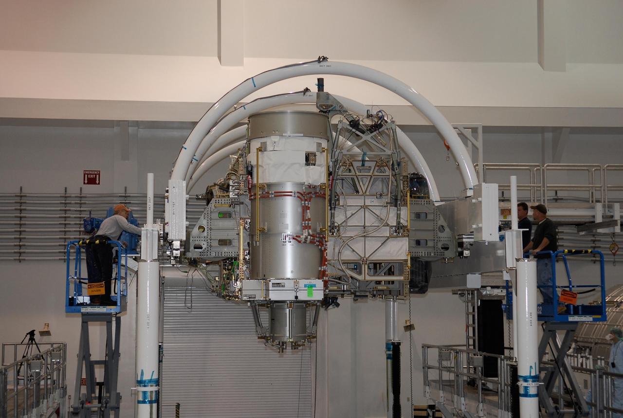 KENNEDY SPACE CENTER, FLA. -- In the Space Station Processing Facility at NASA's Kennedy Space Center, workers check the starboard integrated truss, known as S6, after its full rotation. The truss was rotated in order to remove and replace lower deck batteries. The final starboard truss in the assembly of the International Space Station, the S6 is scheduled to fly on the STS-119 space shuttle mission, whose launch date is not yet determined. Photo credit: NASA/Kim Shiflett