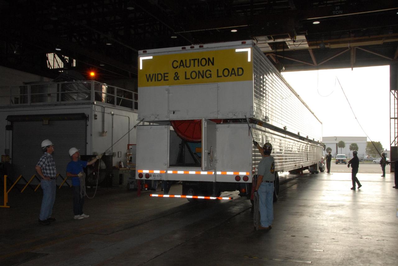 KENNEDY SPACE CENTER, FLA. -- Workers in Hangar M on Cape Canaveral Air Force Station in Florida open the truck trailer to offload the United Launch Alliance Delta II first stage. The Delta rocket will be used to launch the Gamma-Ray Large Area Space Telescope, or GLAST, in May from Launch Pad 17-B on CCAFS.  The GLAST is a powerful space observatory that will explore the Universe's ultimate frontier, where nature harnesses forces and energies far beyond anything possible on Earth;  probe some of science's deepest questions, such as what our Universe is made of, and search for new laws of physics; explain how black holes accelerate jets of material to nearly light speed; and help crack the mystery of stupendously powerful explosions known as gamma-ray bursts.   Photo credit: NASA/George Shelton