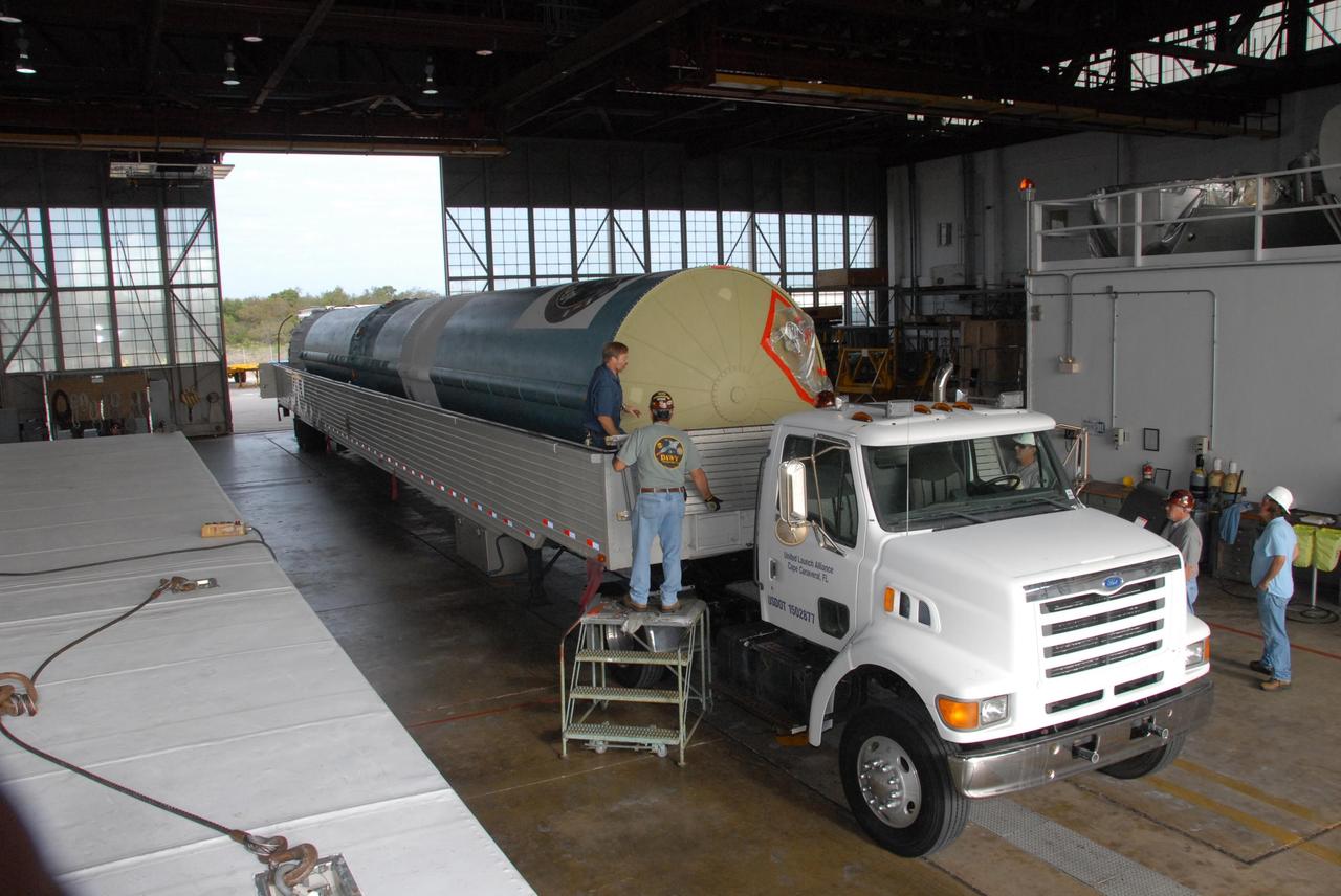 KENNEDY SPACE CENTER, FLA. -- In Hangar M on Cape Canaveral Air Force Station in Florida, the United Launch Alliance Delta II first stage is revealed after the cover was removed from the truck that delivered it.  The Delta rocket will be used to launch the Gamma-Ray Large Area Space Telescope, or GLAST, in May from Launch Pad 17-B on CCAFS. The GLAST is a powerful space observatory that will explore the Universe's ultimate frontier, where nature harnesses forces and energies far beyond anything possible on Earth;  probe some of science's deepest questions, such as what our Universe is made of, and search for new laws of physics; explain how black holes accelerate jets of material to nearly light speed; and help crack the mystery of stupendously powerful explosions known as gamma-ray bursts.   Photo credit: NASA/George Shelton