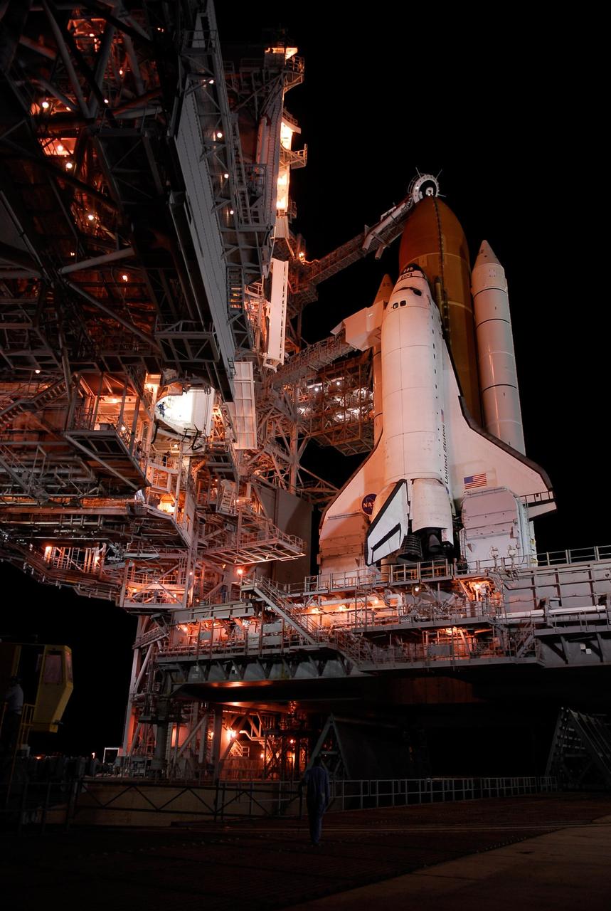 KENNEDY SPACE CENTER, FLA. -- Space shuttle Atlantis is revealed on Launch Pad 39A at NASA's Kennedy Space Center after the rotating service structure, or RSS, at left of the pad, has been rolled back.  Movement of the RSS began at 7:27 p.m. EST.   The RSS provides protected access to the orbiter for crew entry and servicing of payloads at the pad. Rollback of the pad's RSS is one of the milestones in preparation for the launch of mission STS-122, scheduled for 2:45 p.m. EST on Feb. 7.  This will be the third launch attempt for Atlantis since December 2007 to carry the Columbus Laboratory to the International Space Station.  Beneath the shuttle is the mobile launcher platform which supports the shuttle until liftoff.  Photo credit: NASA/Kim Shiflett