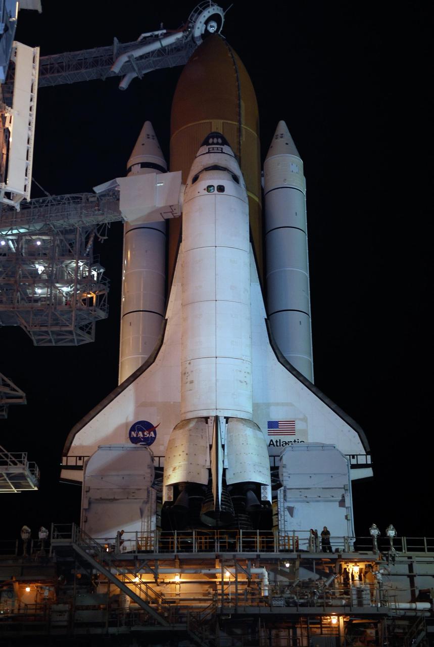 KENNEDY SPACE CENTER, FLA. -- Space shuttle Atlantis is revealed on Launch Pad 39A at NASA's Kennedy Space Center after the rotating service structure, or RSS, at left of the pad, has been rolled back.  Movement of the RSS began at 7:27 p.m. EST.   The RSS provides protected access to the orbiter for crew entry and servicing of payloads at the pad. Rollback of the pad's RSS is one of the milestones in preparation for the launch of mission STS-122, scheduled for 2:45 p.m. EST on Feb. 7.  This will be the third launch attempt for Atlantis since December 2007 to carry the Columbus Laboratory to the International Space Station.  Beneath the shuttle is the mobile launcher platform which supports the shuttle until liftoff.  Photo credit: NASA/Kim Shiflett