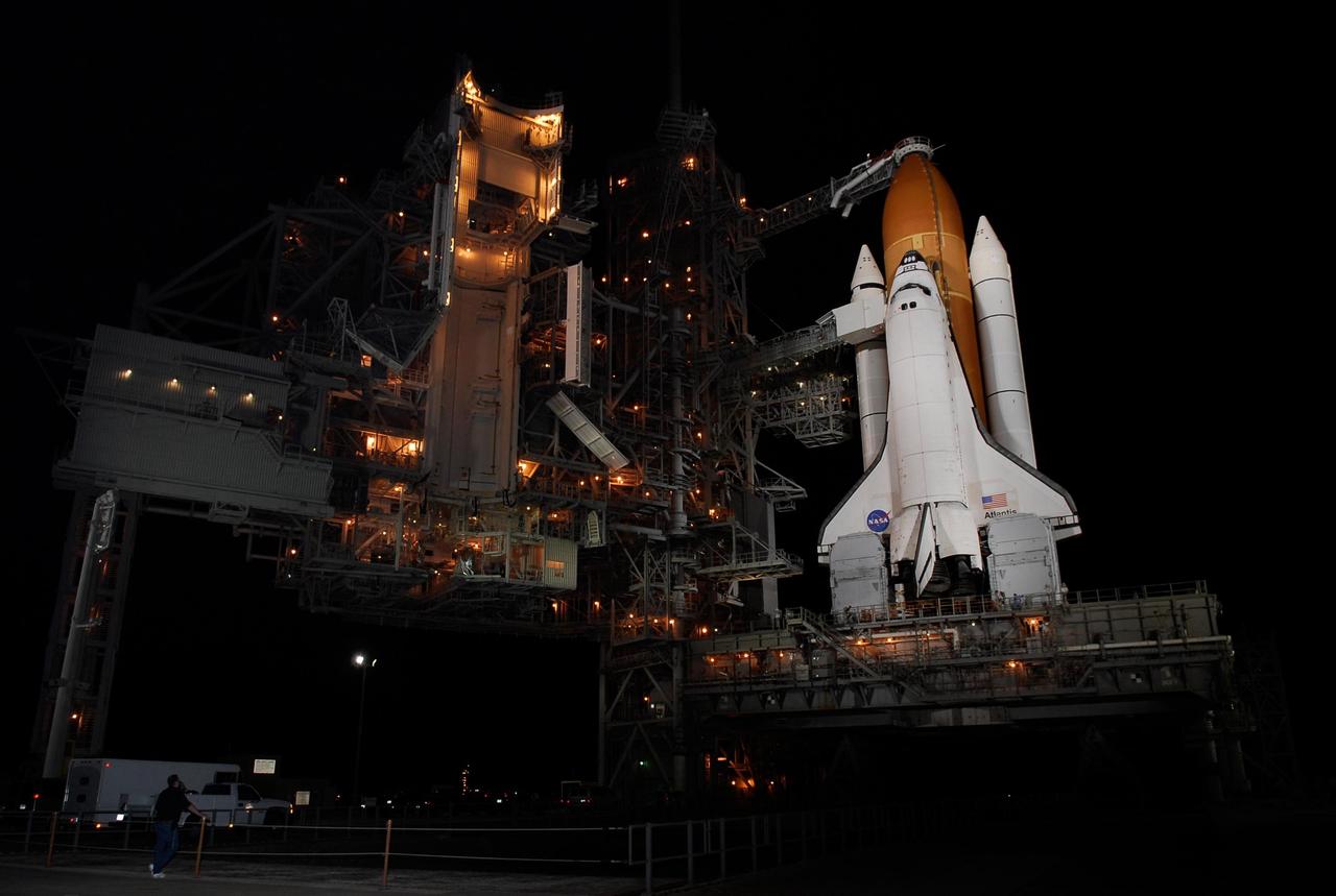 KENNEDY SPACE CENTER, FLA. -- On Launch Pad 39A at NASA's Kennedy Space Center, the rotating service structure, or RSS, at left, has been moved from around space shuttle Atlantis, revealing an empty Payload Changeout Room.  Movement of the RSS began at 7:27 p.m. EST.   The RSS provides protected access to the orbiter for crew entry and servicing of payloads at the pad. Rollback of the pad's RSS is one of the milestones in preparation for the launch of mission STS-122, scheduled for 2:45 p.m. EST on Feb. 7.  This will be the third launch attempt for Atlantis since December 2007 to carry the Columbus Laboratory to the International Space Station.  Beneath the shuttle is the mobile launcher platform which supports the shuttle until liftoff.  Photo credit: NASA/Kim Shiflett