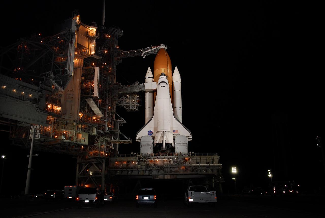 KENNEDY SPACE CENTER, FLA. -- On Launch Pad 39A at NASA's Kennedy Space Center, the rotating service structure, or RSS, at left, has been moved from around space shuttle Atlantis, revealing an illuminated Payload Changeout Room.  Movement of the RSS began at 7:27 p.m. EST.   The RSS provides protected access to the orbiter for crew entry and servicing of payloads at the pad. Rollback of the pad's RSS is one of the milestones in preparation for the launch of mission STS-122, scheduled for 2:45 p.m. EST on Feb. 7.  This will be the third launch attempt for Atlantis since December 2007 to carry the Columbus Laboratory to the International Space Station.  Beneath the shuttle is the mobile launcher platform which supports the shuttle until liftoff.  Photo credit: NASA/Kim Shiflett
