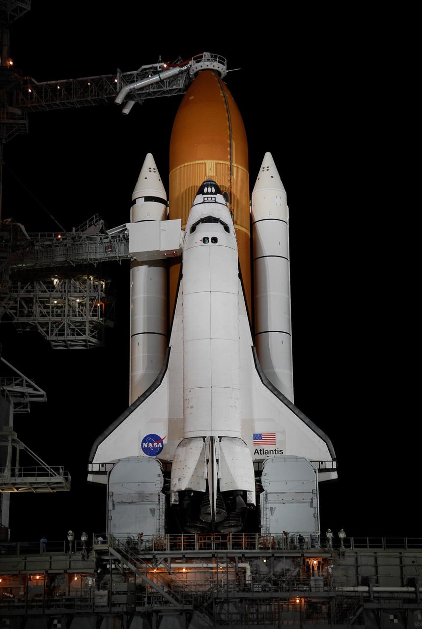 KENNEDY SPACE CENTER, FLA. -- On Launch Pad 39A at NASA's Kennedy Space Center, the orbiter access arm, which extends from the Fixed Service Structure, is positioned against space shuttle Atlantis following the rollback of the rotating service structure, or RSS.  Movement of the RSS began at 7:27 p.m. EST.    The RSS provides protected access to the orbiter for crew entry and servicing of payloads at the pad. Rollback of the pad's RSS is one of the milestones in preparation for the launch of mission STS-122, scheduled for 2:45 p.m. EST on Feb. 7.  This will be the third launch attempt for Atlantis since December 2007 to carry the Columbus Laboratory to the International Space Station.  Beneath the shuttle is the mobile launcher platform which supports the shuttle until liftoff.  Photo credit: NASA/Kim Shiflett