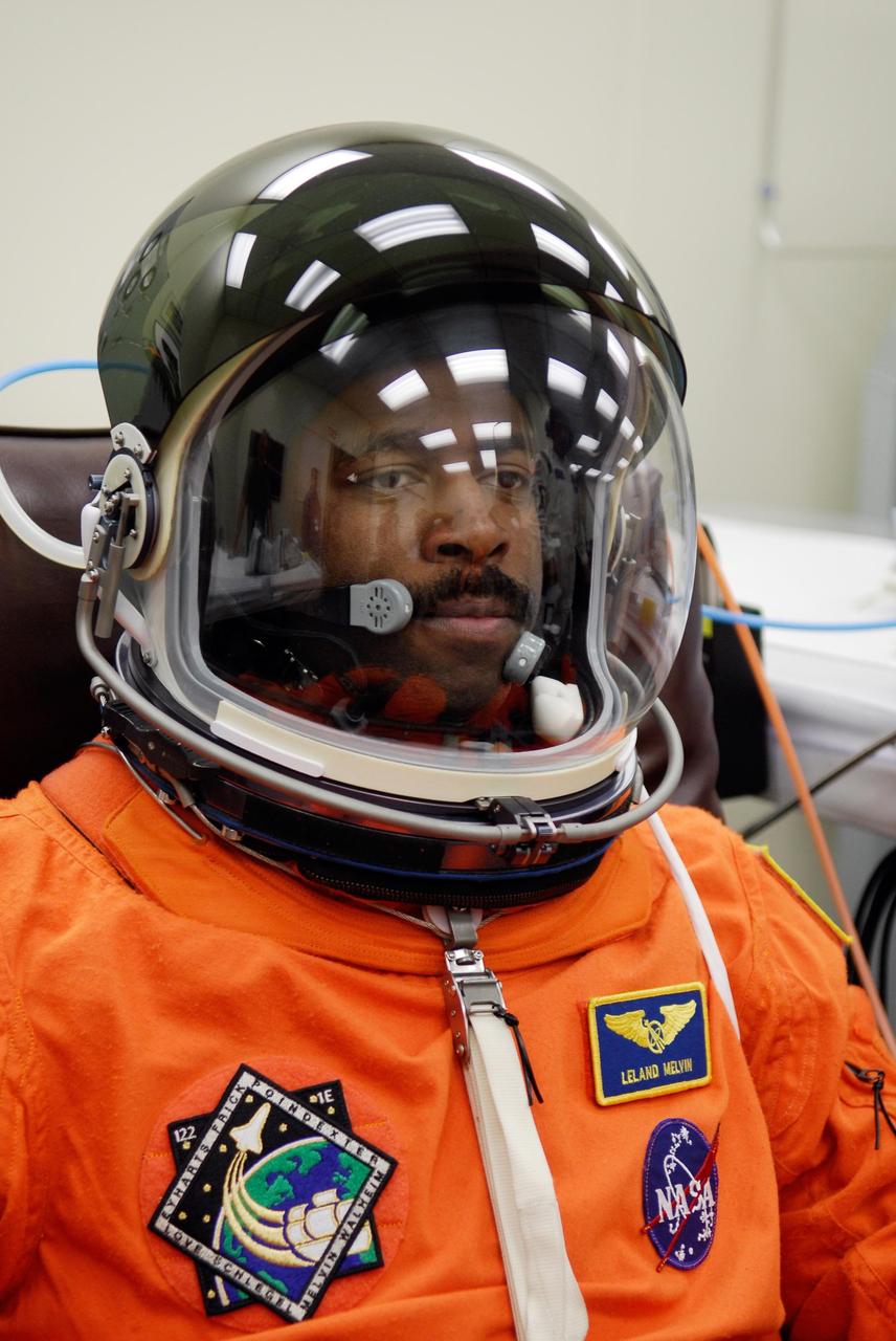 KENNEDY SPACE CENTER, FLA. -- Mission Specialist Leland Melvin completes his suitup by donning the helmet he'll wear during launch of space shuttle Atlantis on the STS-122 mission. The launch, scheduled for 2:45 p.m. EST, will be the third attempt for Atlantis since December 2007 to carry the European Space Agency's Columbus laboratory to the International Space Station. During the 11-day mission, the crew's prime objective is to attach the laboratory to the Harmony module, adding to the station's size and capabilities. Photo credit: NASA/Kim Shiflett