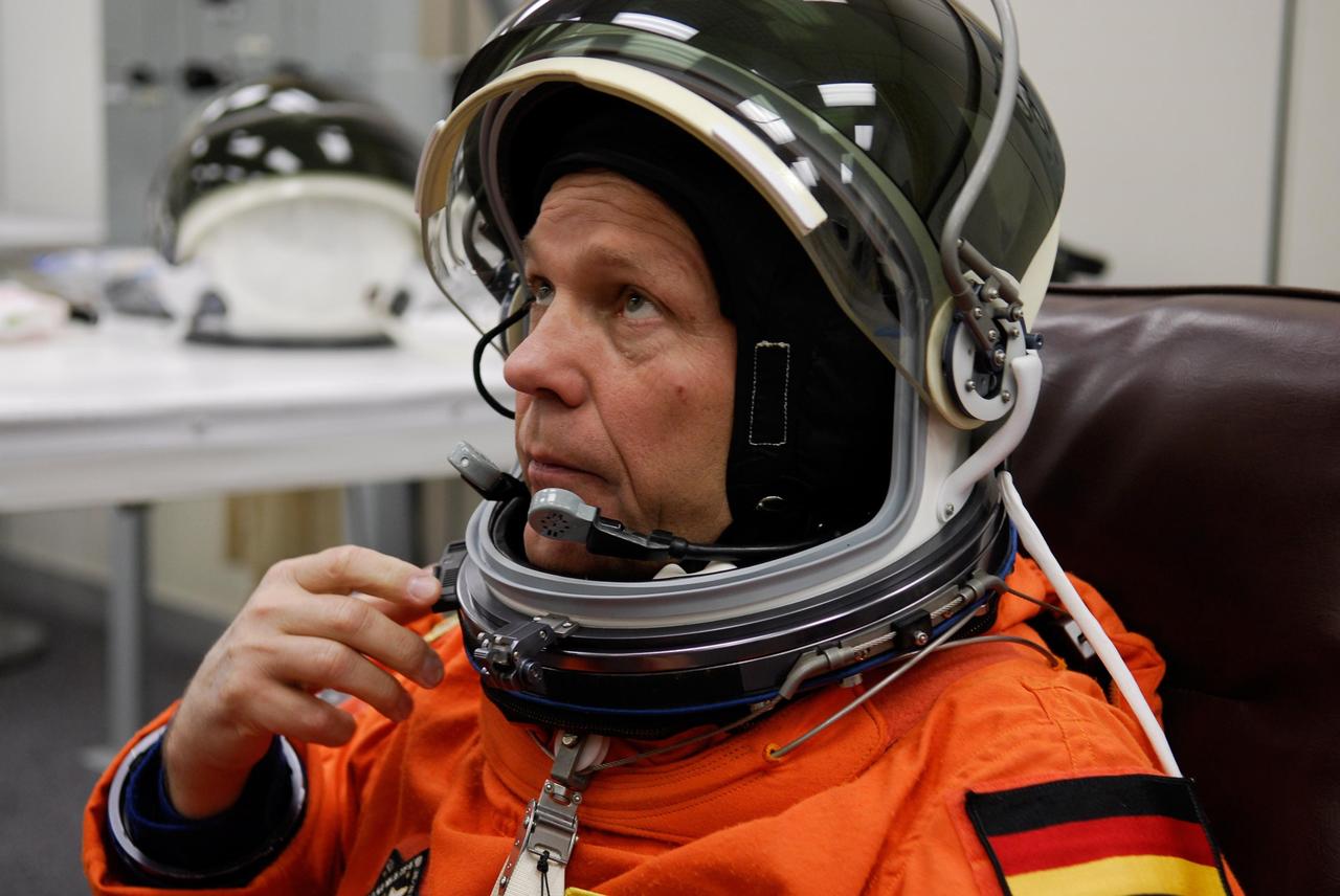 KENNEDY SPACE CENTER, FLA. -- Mission Specialist Hans Schlegel dons his helmet for launch of space shuttle Atlantis on the STS-122 mission. Schlegel represents the European Space Agency. The launch, scheduled for 2:45 p.m. EST, will be the third attempt for Atlantis since December 2007 to carry the European Space Agency's Columbus laboratory to the International Space Station. During the 11-day mission, the crew's prime objective is to attach the laboratory to the Harmony module, adding to the station's size and capabilities. Photo credit: NASA/Kim Shiflett