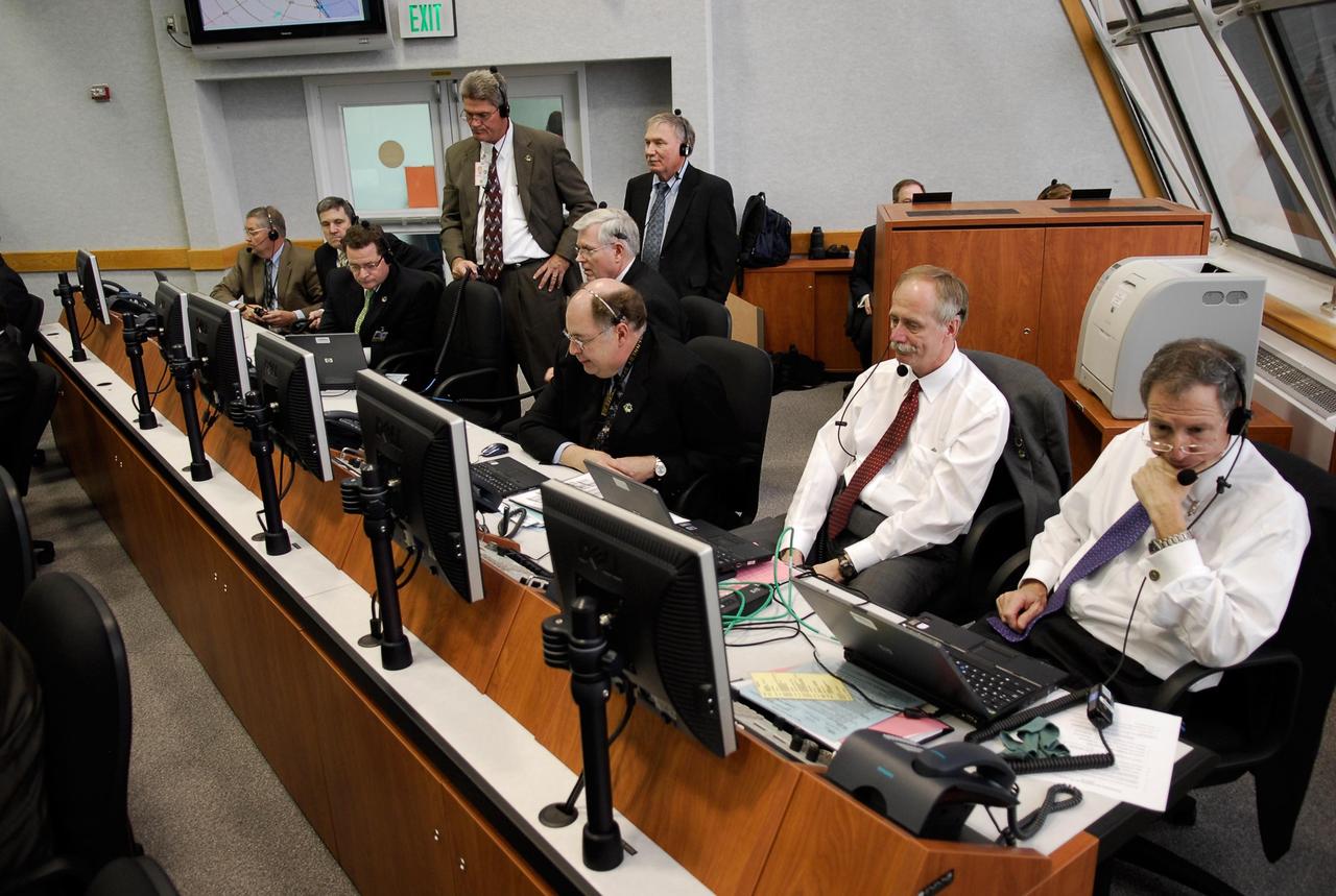KENNEDY SPACE CENTER, FLA. --  Inside the Launch Control Center at NASA's Kennedy Space Center, NASA management watches and waits for the launch of space shuttle Atlantis on the STS-122 mission to the International Space Station.  From right are NASA Administrator Mike Griffin, Associate Administrator for NASA Space Operations William H. Gerstenmaier, Shuttle Program Manager Wayne Hale.  Standing on the left is Center Director Bill Parsons. The launch is the third attempt for Atlantis since December 2007 to carry the European Space Agency's Columbus laboratory to the International Space Station.  During the 11-day mission, the crew's prime objective is to attach the laboratory to the Harmony module, adding to the station's size and capabilities.    Photo credit: NASA/Kim Shiflett