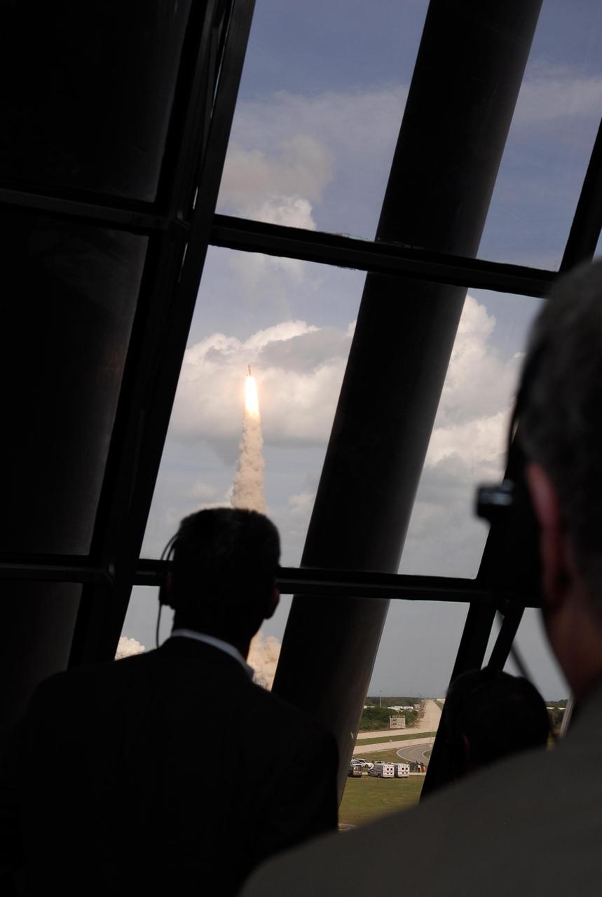 KENNEDY SPACE CENTER, FLA. -- The launch of space shuttle Atlantis is viewed through the windows of the Launch Control Center, where VIPS gathered to watch, including Center Director Bill Parsons, Associate Administrator for NASA Space Operations William H. Gerstenmaier and NASA Administrator Mike Griffin.  Liftoff was on time at 2:45 p.m. EST from Launch Pad 39A. The launch is the third attempt for Atlantis since December 2007 to carry the European Space Agency's Columbus laboratory to the International Space Station.  During the 11-day mission, the crew's prime objective is to attach the laboratory to the Harmony module, adding to the station's size and capabilities.    Photo credit: NASA/Kim Shiflett