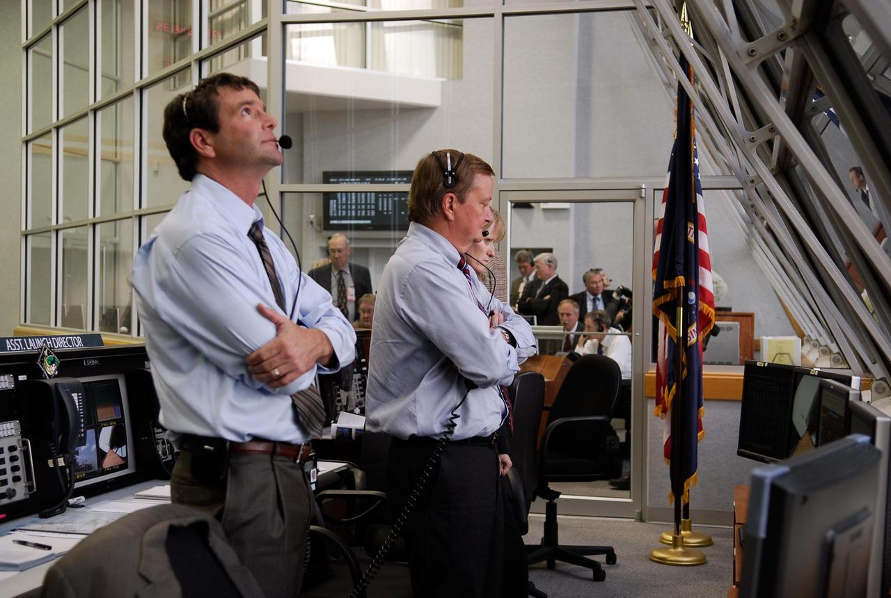 KENNEDY SPACE CENTER, FLA. -- Inside the Launch Control Center Firing Room at NASA's Kennedy Space Center, STS-122 Launch Director Doug Lyons (left) and Shuttle Launch Director Mike Leinbach watch the launch of space shuttle Atlantis on the STS-122 mission to the International Space Station. Liftoff was on time at 2:45 p.m. EST from Launch Pad 39A. The launch is the third attempt for Atlantis since December 2007 to carry the European Space Agency's Columbus laboratory to the International Space Station. During the 11-day mission, the crew's prime objective is to attach the laboratory to the Harmony module, adding to the station's size and capabilities. Photo credit: NASA/Kim Shiflett