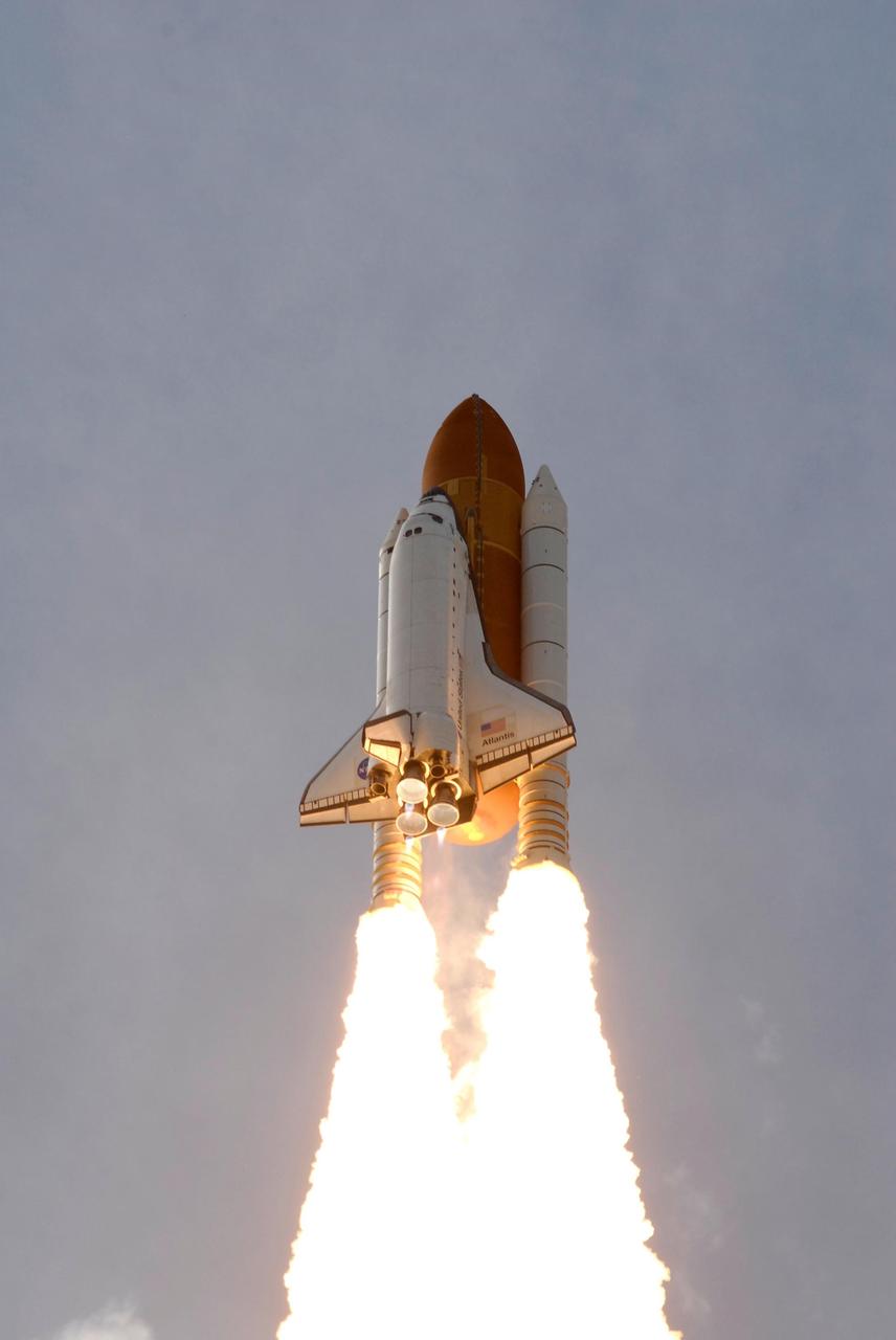 KENNEDY SPACE CENTER, FLA. --  Twin columns of fire help propel space shuttle Atlantis into space on mission STS-122 to the International Space Station.  Liftoff was on time at 2:45 p.m. EST.  Below the nozzles of the main engines are the blue cones of light, known as shock or mach diamonds. They are a formation of shock waves in the exhaust plume of an aerospace propulsion system.  The launch is the third attempt for Atlantis since December 2007 to carry the European Space Agency's Columbus laboratory to the International Space Station.  During the 11-day mission, the crew's prime objective is to attach the laboratory to the Harmony module, adding to the station's size and capabilities.    Photo credit: NASA/Jerry Cannon, Rusty Backer