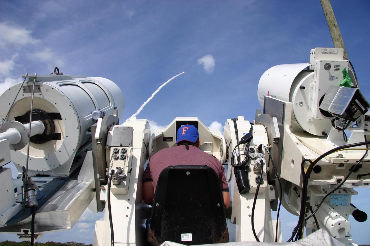 KENNEDY SPACE CENTER, FLA. --  Tim Terry, with Kennedy Space Center Integrated Communications Services, sits at the controls of a long-range tracking camera during the launch of space shuttle Atlantis on mission STS-122.  Liftoff was on time at 2:45 p.m. EST.  Long-range cameras are used during early phases of ascent to identify and track debris and continue to be used as long as the vehicle is visible.  During the 11-day mission, the crew's prime objective is to attach the Columbus laboratory to the Harmony module, adding to the International Space Station's size and capabilities.   Photo credit: NASA/Kenny Allen