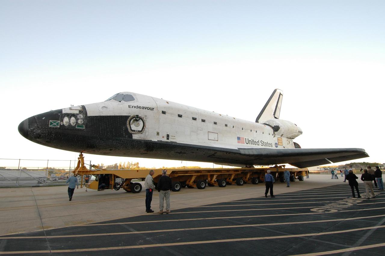 KENNEDY SPACE CENTER, FLA. -- On its transporter, space shuttle Endeavour turns away from the Orbiter Processing Facility to start the rollover to the Vehicle Assembly Building. In high bay 1 of the VAB, Endeavour will be attached to its external fuel tank and solid rocket boosters in preparation for its upcoming mission, STS-123, to the International Space Station targeted for March 11. The mission will deliver the first section of the Japan Aerospace Exploration Agency's Kibo laboratory and the Canadian Space Agency's two-armed robotic system, Dextre. Photo credit: NASA/Jim Grossmann