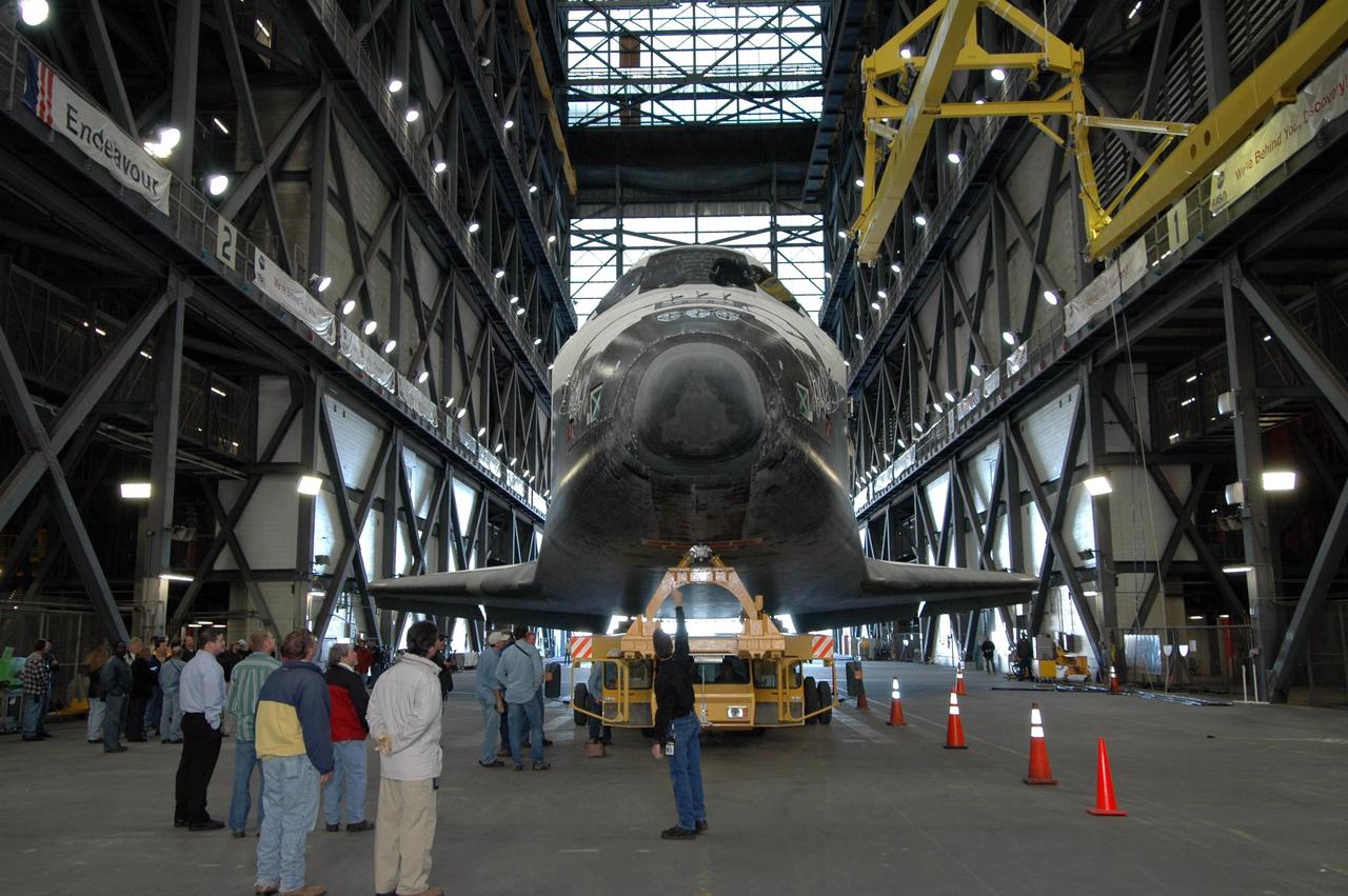 KENNEDY SPACE CENTER, FLA. -- In the transfer aisle of the Vehicle Assembly Building, space shuttle Endeavour waits for the overhead crane (upper right) to be attached.  The crane will raise and then lift Endeavour into high bay 1. There, Endeavour will be attached to its external fuel tank and solid rocket boosters in preparation for its upcoming mission, STS-123, to the International Space Station targeted for March 11.  The mission will deliver the first section of the Japan Aerospace Exploration Agency's Kibo laboratory and the Canadian Space Agency's two-armed robotic system, Dextre.   Photo credit: NASA/Jim Grossmann