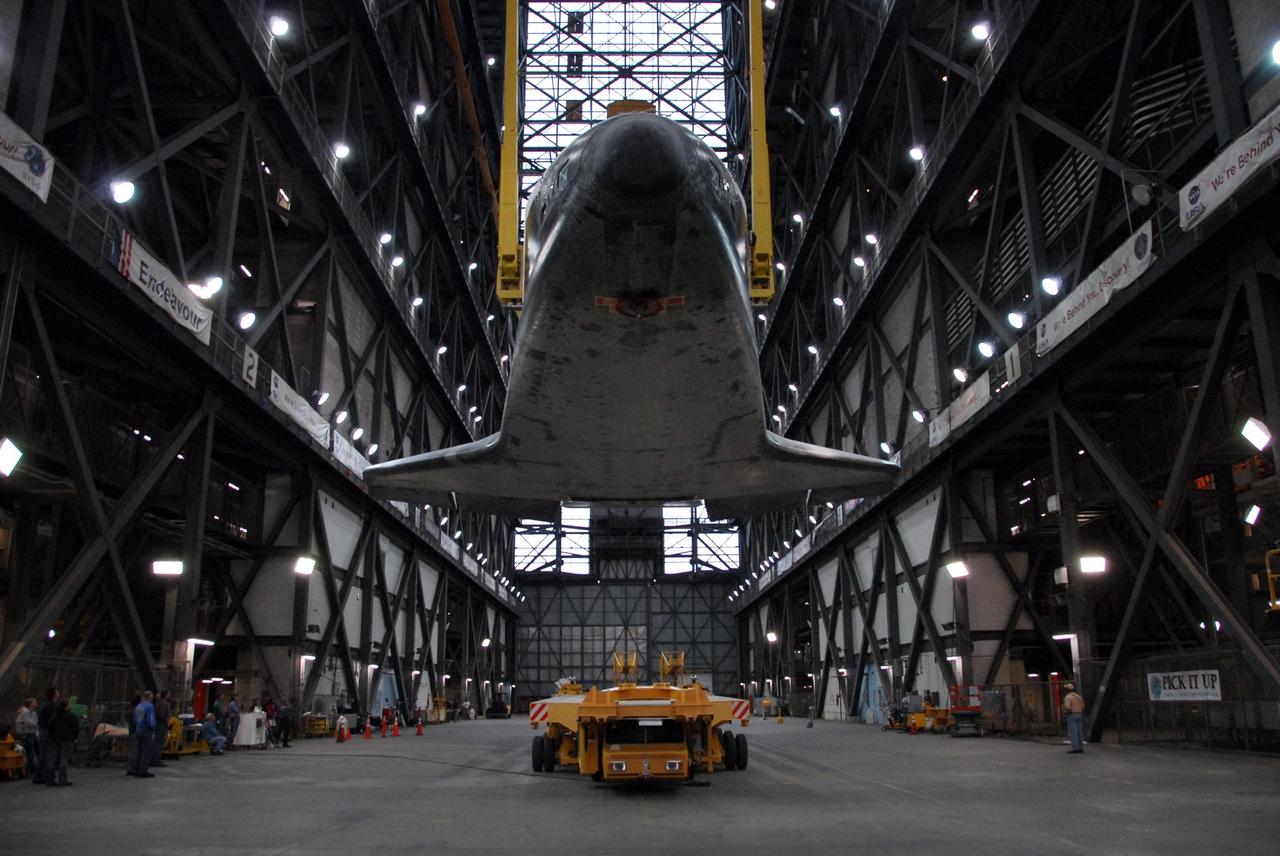 KENNEDY SPACE CENTER, FLA. -- In the transfer aisle of the Vehicle Assembly Building, space shuttle Endeavour is lifted off its transporter. The shuttle will be raised to a vertical position and lifted up into high bay 1 to be attached to its external fuel tank and solid rocket boosters in preparation for launch on the STS-123 mission, targeted for March 11. The mission will deliver the first section of the Japan Aerospace Exploration Agency's Kibo laboratory and the Canadian Space Agency's two-armed robotic system, Dextre. Photo credit: NASA/Dimitri Gerondidakis