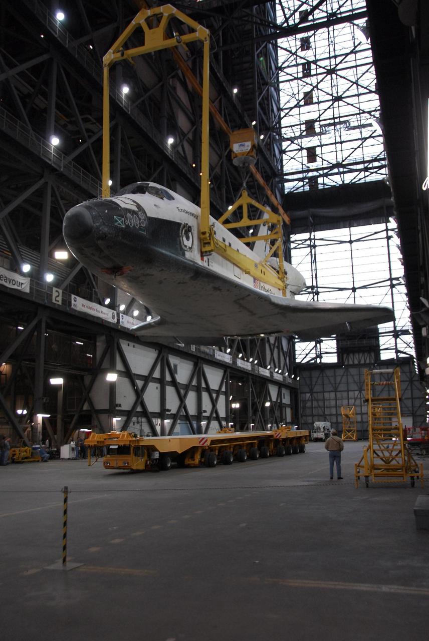 KENNEDY SPACE CENTER, FLA. --  In the transfer aisle of the Vehicle Assembly Building, space shuttle Endeavour is lifted off its transporter.  The shuttle will be raised to a vertical position and lifted up into high bay 1 to be attached to its external fuel tank and solid rocket boosters in preparation for launch on the STS-123 mission, targeted for March 11.   The mission will deliver the first section of the Japan Aerospace Exploration Agency's Kibo laboratory and the Canadian Space Agency's two-armed robotic system, Dextre.   Photo credit: NASA/Dimitri Gerondidakis