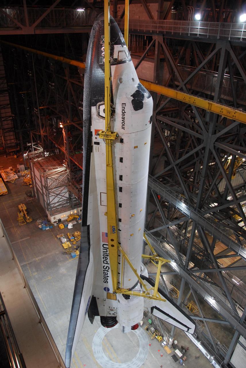 KENNEDY SPACE CENTER, FLA. -- Viewed from an upper level in the Vehicle Assembly Building, space shuttle Endeavour is slowly lifted to the top of high bay 1. Crossing the I-beam, the shuttle will then be lowered onto the mobile launcher platform for mating with the external tank and solid rocket boosters in preparation for launch on the STS-123 mission, targeted for March 11. The mission will deliver the first section of the Japan Aerospace Exploration Agency's Kibo laboratory and the Canadian Space Agency's two-armed robotic system, Dextre. Photo credit: NASA/Dimitri Gerondidakis