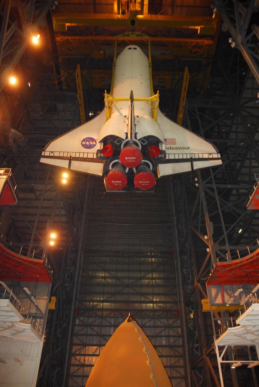 KENNEDY SPACE CENTER, FLA. --  In the Vehicle Assembly Building, space shuttle Endeavour is lowered into high bay 1 toward the external tank seen below.  The shuttle will be mated with the tank and solid rocket boosters in preparation for launch on the STS-123 mission, targeted for March 11.  The mission will deliver the first section of the Japan Aerospace Exploration Agency's Kibo laboratory and the Canadian Space Agency's two-armed robotic system, Dextre.   Photo credit: NASA/Dimitri Gerondidakis