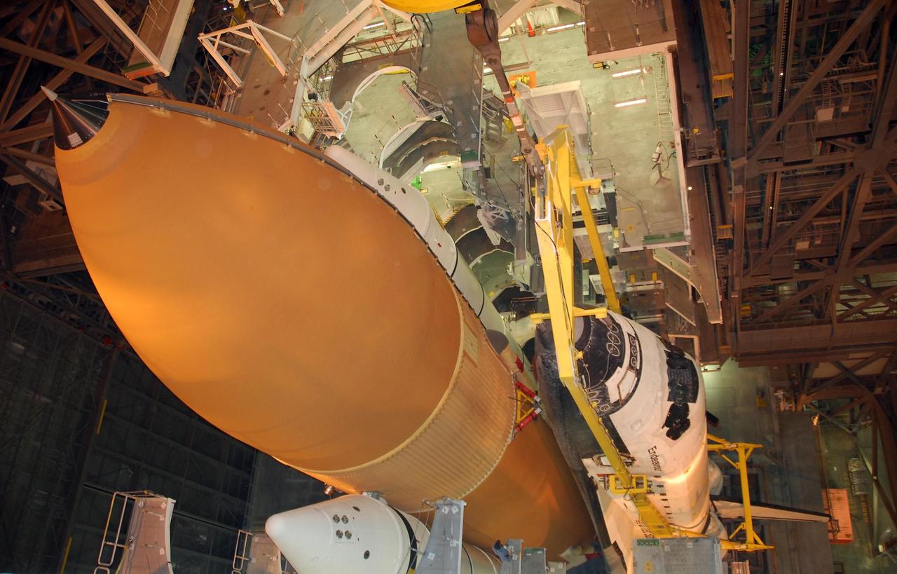 KENNEDY SPACE CENTER, FLA. --  A view from above shows space shuttle Endeavour lowered onto the mobile launcher platform next to the external tank flanked by two solid rocket boosters.  The shuttle will be mated to the tank and boosters in preparation for launch on the STS-123 mission, targeted for March 11.  The mission will deliver the first section of the Japan Aerospace Exploration Agency's Kibo laboratory and the Canadian Space Agency's two-armed robotic system, Dextre.   Photo credit: NASA/Dimitri Gerondidakis