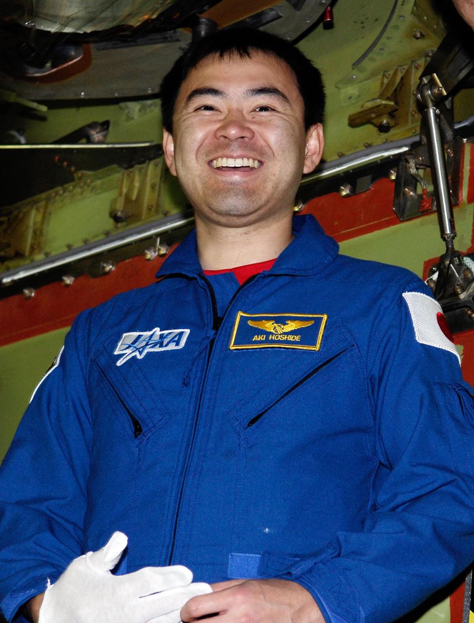 KENNEDY SPACE CENTER, FLA. -- STS-124 Mission Specialist Akihiko Hoshide looks over space shuttle Discovery in the Orbiter Processing Facility bay 2 at NASA's Kennedy Space Center. Members of the crew are at Kennedy for a crew equipment interface test. Hoshide represents the Japan Aerospace Exploration Agency, called JAXA. On the mission, Discovery will transport the Kibo Japanese Experiment Module - Pressurized Module (JEM-PM) and the Japanese Remote Manipulator System (JEM-RMS) to the International Space Station to complete the Kibo laboratory. The launch of Discovery is targeted for April 24. Photo credit: NASA/Kim Shiflett