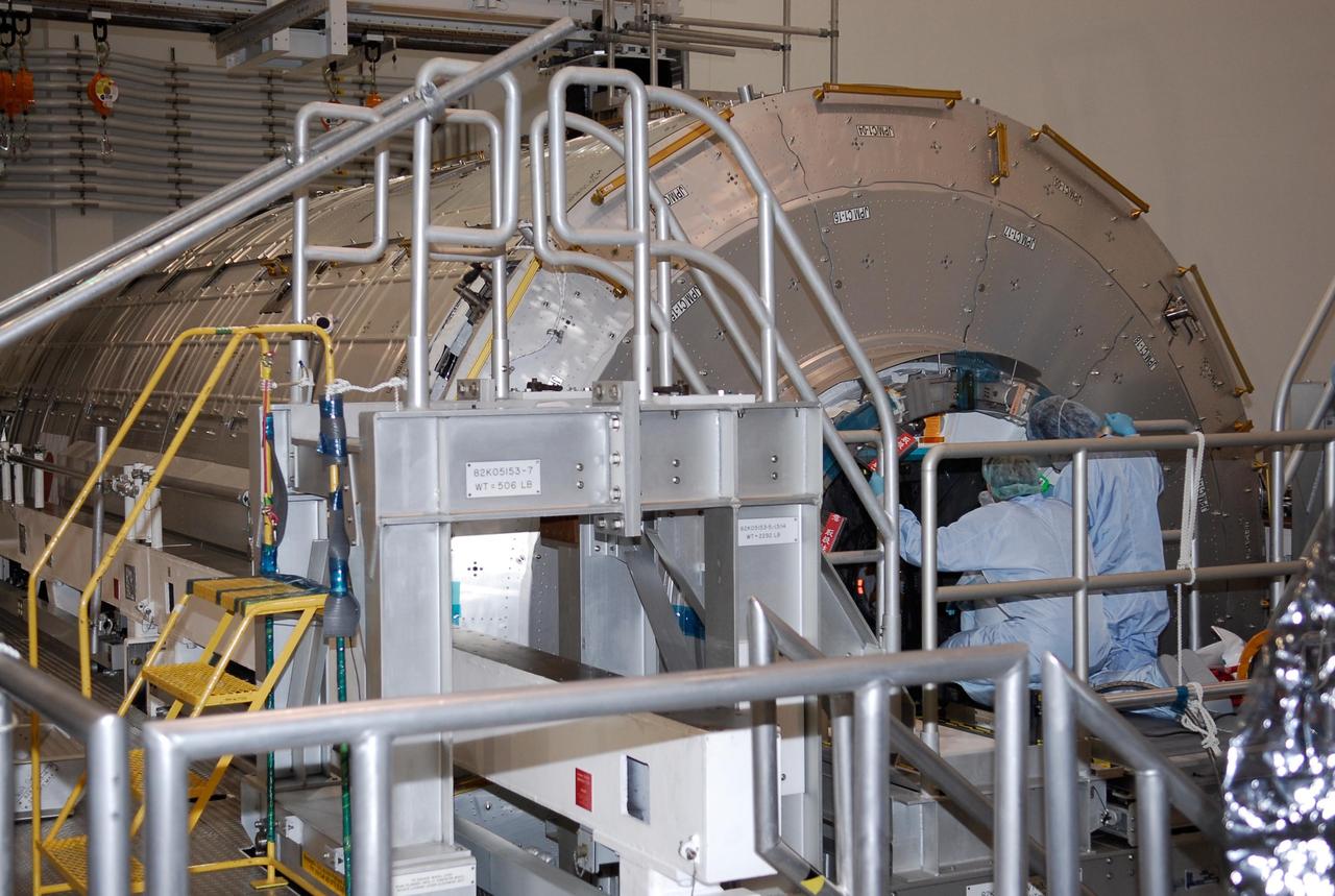 KENNEDY SPACE CENTER, FLA. --  In the Space Station Processing Facility at NASA's Kennedy Space Center, workers prepare to close the hatch on the Japanese Experiment Module, called Kibo.  The closing is in preparation for the transfer to a payload canister and the move to the launch pad. On the mission, space shuttle Discovery will transport the Kibo module and the Japanese Remote Manipulator System, or JEM-RMS, to complete the Kibo laboratory.  The launch of Discovery is targeted for April 24.   Photo credit: NASA/Kim Shiflett