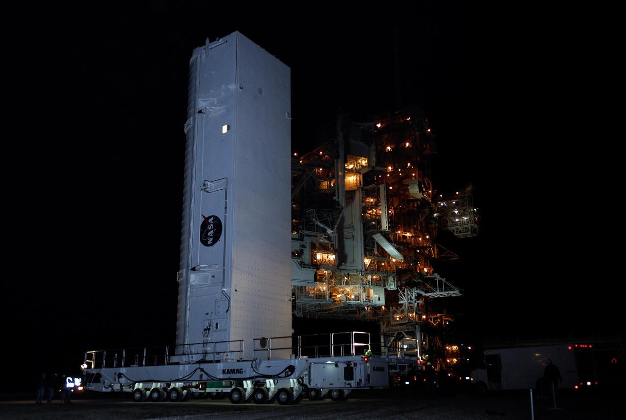 KENNEDY SPACE CENTER, FLA. --  The payload canister containing the first section of the Japan Aerospace Exploration Agency's Kibo laboratory and the Canadian Space Agency's two-armed robotic system, Dextre, nears the rotating service structure on Launch Pad 39A at NASA's Kennedy Space Center.  The payload will be transferred to the payload changeout room on the service structure.  The changeout room is the enclosed, environmentally controlled portion of the rotating service structure that supports cargo delivery to the pad and subsequent vertical installation into an orbiter's payload bay.  The payload will be installed into Endeavour for launch on the STS-123 mission targeted for March 11.  Photo credit: NASA/Kim Shiflett