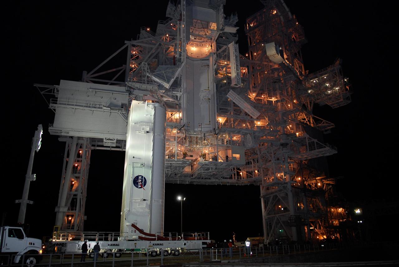 KENNEDY SPACE CENTER, FLA. --  The payload canister containing the first section of the Japan Aerospace Exploration Agency's Kibo laboratory and the Canadian Space Agency's two-armed robotic system, Dextre, nears the rotating service structure on Launch Pad 39A at NASA's Kennedy Space Center.  The payload will be transferred to the payload changeout room on the service structure. The changeout room is the enclosed, environmentally controlled portion of the rotating service structure that supports cargo delivery to the pad and subsequent vertical installation into an orbiter's payload bay.  The payload will be installed into Endeavour for launch on the STS-123 mission targeted for March 11.  Photo credit: NASA/Kim Shiflett