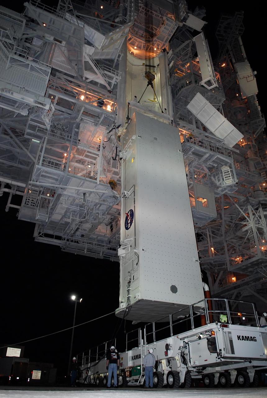 KENNEDY SPACE CENTER, FLA. --  On Launch Pad 39A at NASA's Kennedy Space Center, the payload canister containing the first section of the Japan Aerospace Exploration Agency's Kibo laboratory and the Canadian Space Agency's two-armed robotic system, Dextre, is lifted up toward the payload changeout room in the rotating service structure.  The changeout room is the enclosed, environmentally controlled portion of the rotating service structure that supports cargo delivery to the pad and subsequent vertical installation into an orbiter's payload bay.  The payload will be installed into Endeavour for launch on the STS-123 mission targeted for March 11.  Photo credit: NASA/Kim Shiflett