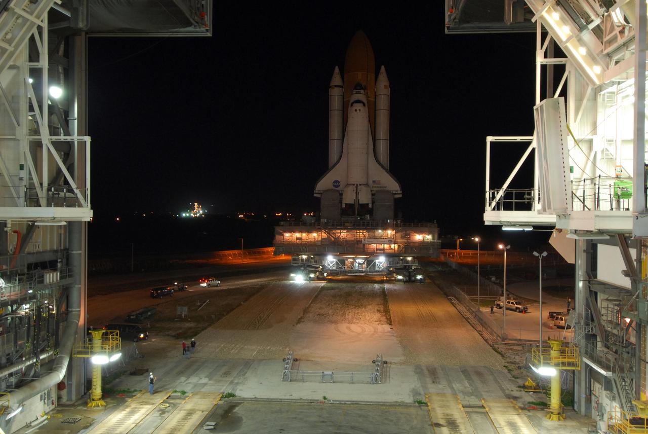 KENNEDY SPACE CENTER, FLA. -- Getting ready for the STS-123 mission, space shuttle Endeavour begins rollout to Launch Pad 39A. Lights below the shuttle fill the mobile launcher platform. The lights below that illuminate the crawler transporter. At left in the background is the lighted launch pad. The journey from the Vehicle Assembly Building began at 11:24 p.m. on Feb. 17, approximately 30 minutes before it's scheduled start time due to favorable weather conditions. The shuttle arrived at the launch pad at 4:45 a.m. Monday and was hard down at 6:22 a.m. On the mission, Endeavour and its crew will deliver the first section of the Japan Aerospace Exploration Agency's Kibo laboratory and the Canadian Space Agency's two-armed robotic system, Dextre. Launch is targeted for March 11. Photo credit: NASA/Amanda Diller