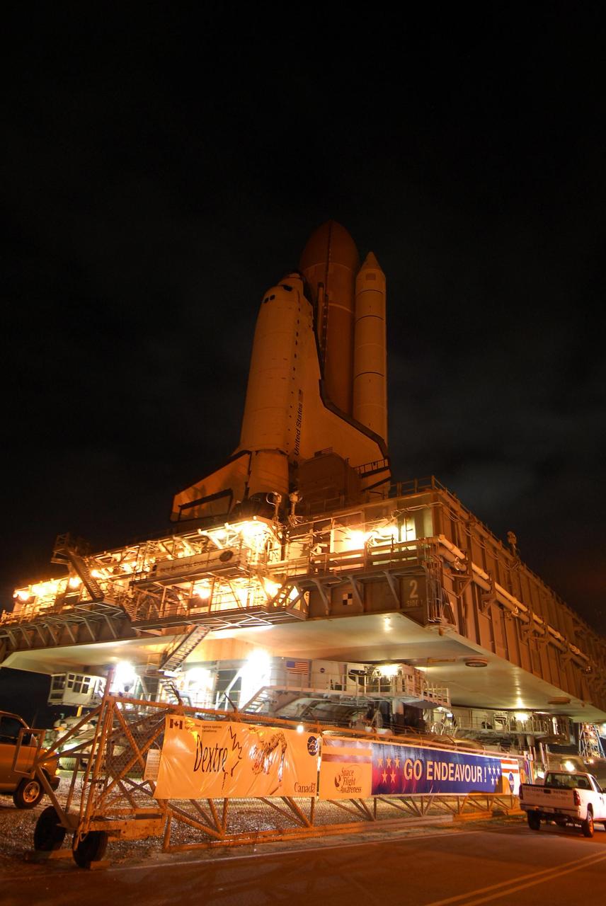 KENNEDY SPACE CENTER, FLA. --   Getting ready for the STS-123 mission, space shuttle Endeavour, atop the well-lighted mobile launcher platform, passes through the gate on Launch Pad 39A.   The journey from the Vehicle Assembly Building began at 11:24 p.m. on Feb. 17, approximately 30 minutes before it's scheduled start time due to favorable weather conditions. The shuttle arrived at the launch pad at 4:45 a.m. Monday and was hard down at 6:22 a.m. On the mission, Endeavour and its crew will deliver the first section of the Japan Aerospace Exploration Agency's Kibo laboratory and the Canadian Space Agency's two-armed robotic system, Dextre.  Launch is targeted for March 11.    Photo credit: NASA/Amanda Diller