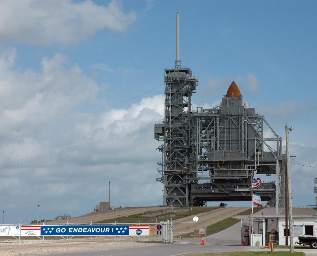 KENNEDY SPACE CENTER, FLA. -- The rotating service structure has closed around space shuttle Endeavour, with only the tip of the external tank showing in this view. To its left is the fixed service structure with the lightning mast on top. Endeavour is being prepared for launch on the STS-123 mission targeted for March 11. Photo credit: NASA/Jack Pfaller