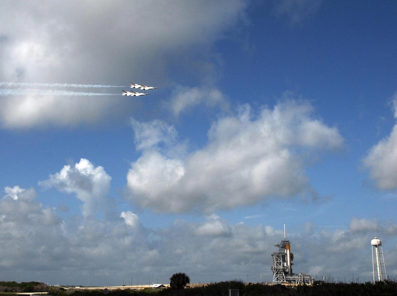 KENNEDY SPACE CENTER, FLA. -- The U.S. Air Force Thunderbirds, at left, fly past Launch Pad 39A at NASA's Kennedy Space Center where space shuttle Endeavour (lower right) waits to launch on the STS-123 mission.  The aircraft had flown earlier to support the Daytona 500, also celebrating its 50th anniversary, and chose to fly over Kennedy on their way to their next assignment.  Endeavour is being prepared for launch on the STS-123 mission targeted for March 11. Photo credit: NASA/Jack Pfaller