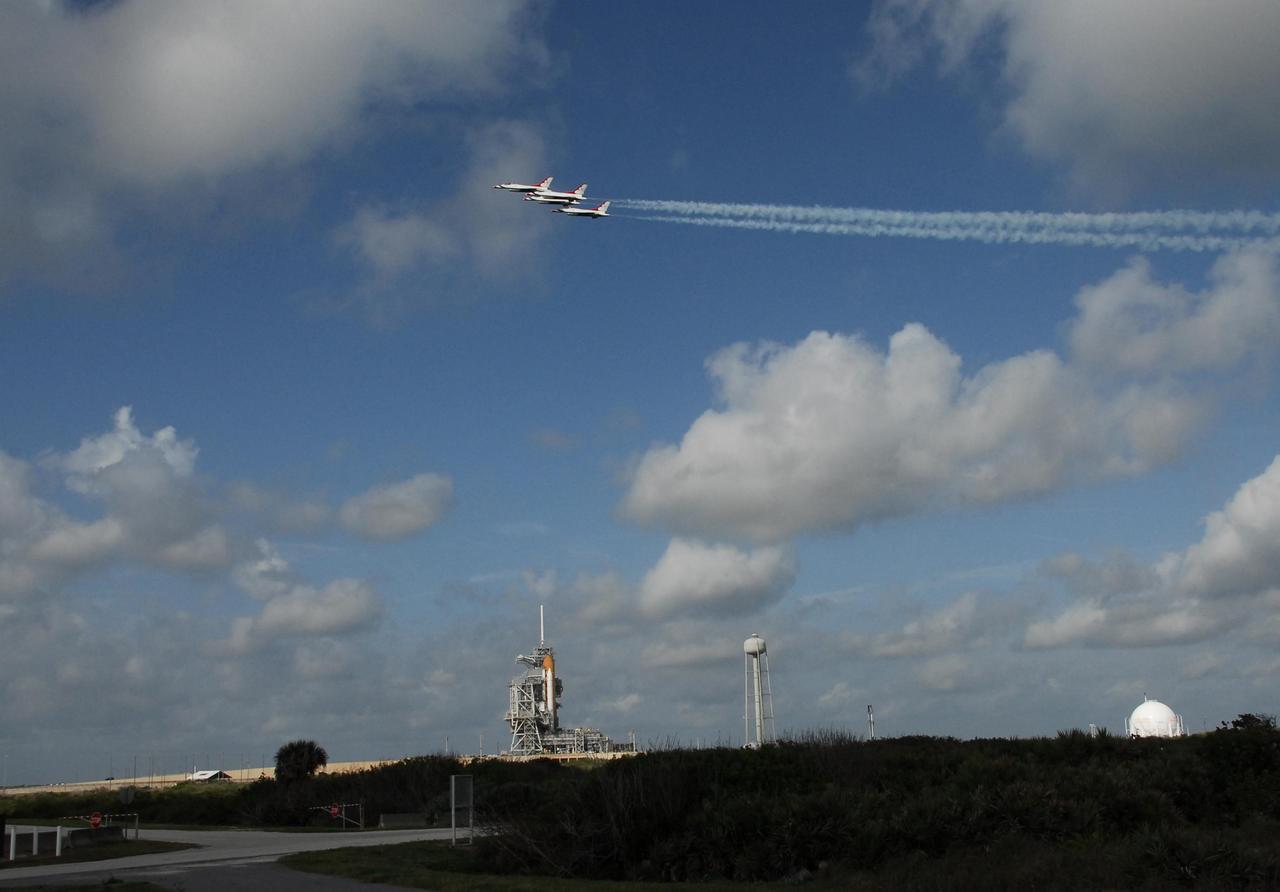 KENNEDY SPACE CENTER, FLA. -- The U.S. Air Force Thunderbirds fly over NASA's Kennedy Space Center in commemoration of NASA's 50th anniversary.  The aircraft had flown earlier to support the Daytona 500, also celebrating its 50th anniversary, and chose to fly over Kennedy on their way to their next assignment.  Below them is space shuttle Endeavour, waiting to launch on the STS-123 mission targeted for March 11.  Photo credit: NASA/Jack Pfaller