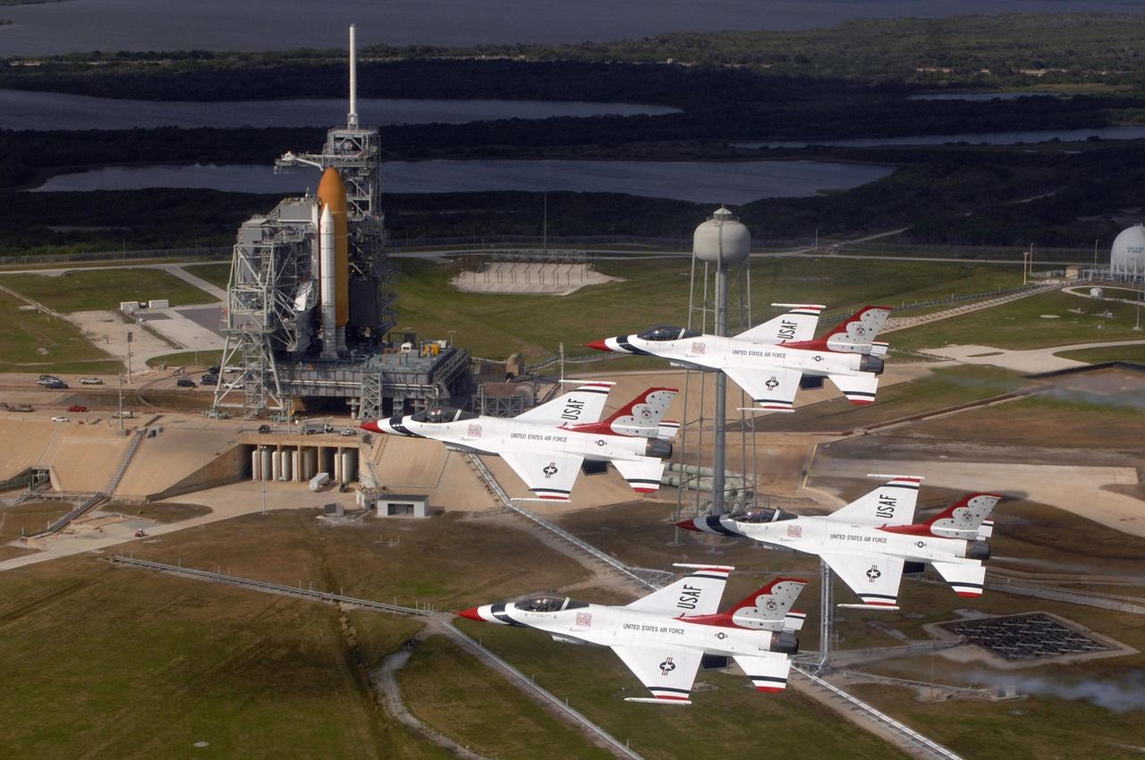 KENNEDY SPACE CENTER, FLA. -- The U.S. Air Force Thunderbirds fly past Launch Pad 39A at NASA's Kennedy Space Center in commemoration of NASA's 50th anniversary.  The aircraft had flown earlier to support the Daytona 500, also celebrating its 50th anniversary, and chose to fly over Kennedy on their way to their next assignment.  On the pad, space shuttle Endeavour waits to launch on the STS-123 mission. Photo courtesy of USAF/TSgt. Justin D. Pyle